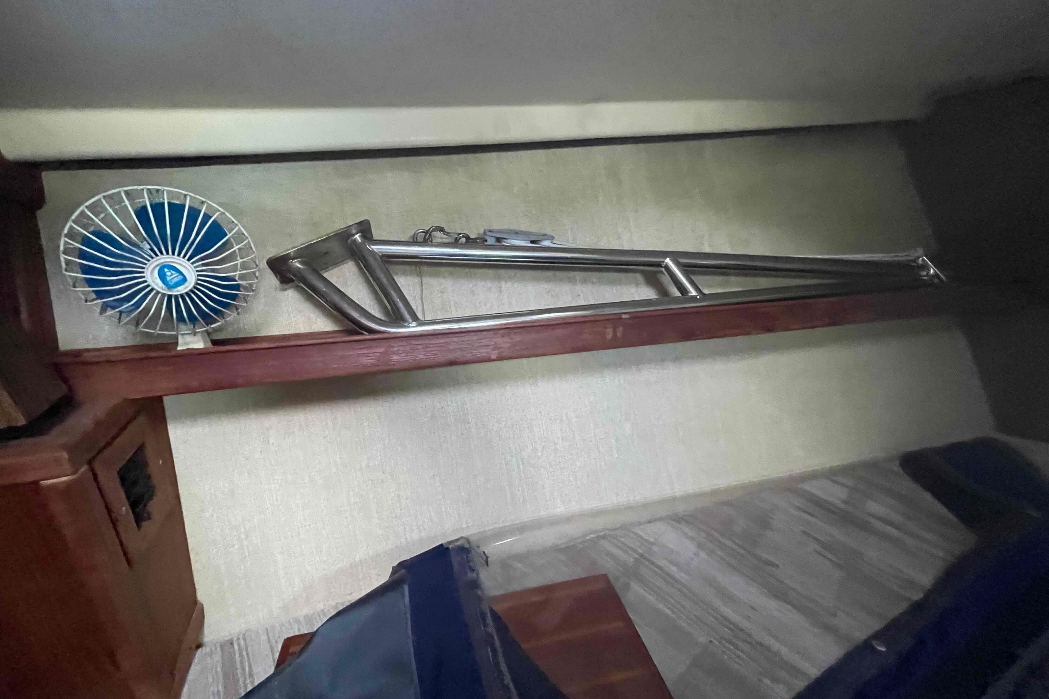 Small fan and metal frame inside 1990 Island Packet 35 Cutter sailboat cabin.