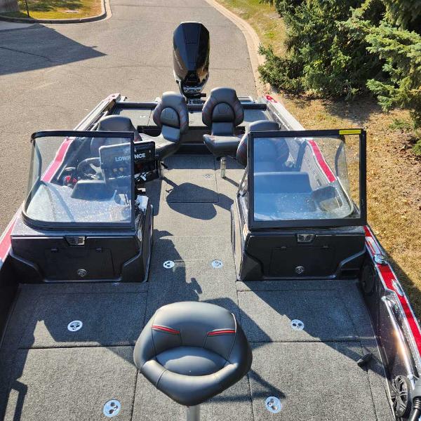 2024 Nitro ZV20 Pro fishing boat with seating and windshield, parked on a sunny day.