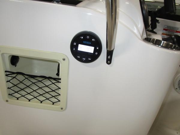 2023 Bayliner 210EL boat interior with control panel and storage compartment.
