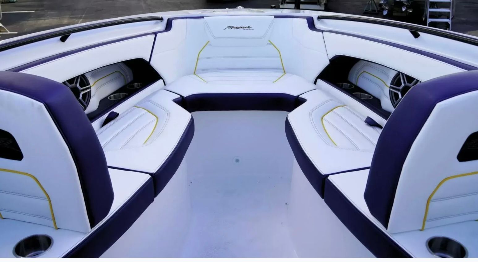 Interior view of a modern boat with white and purple seating.