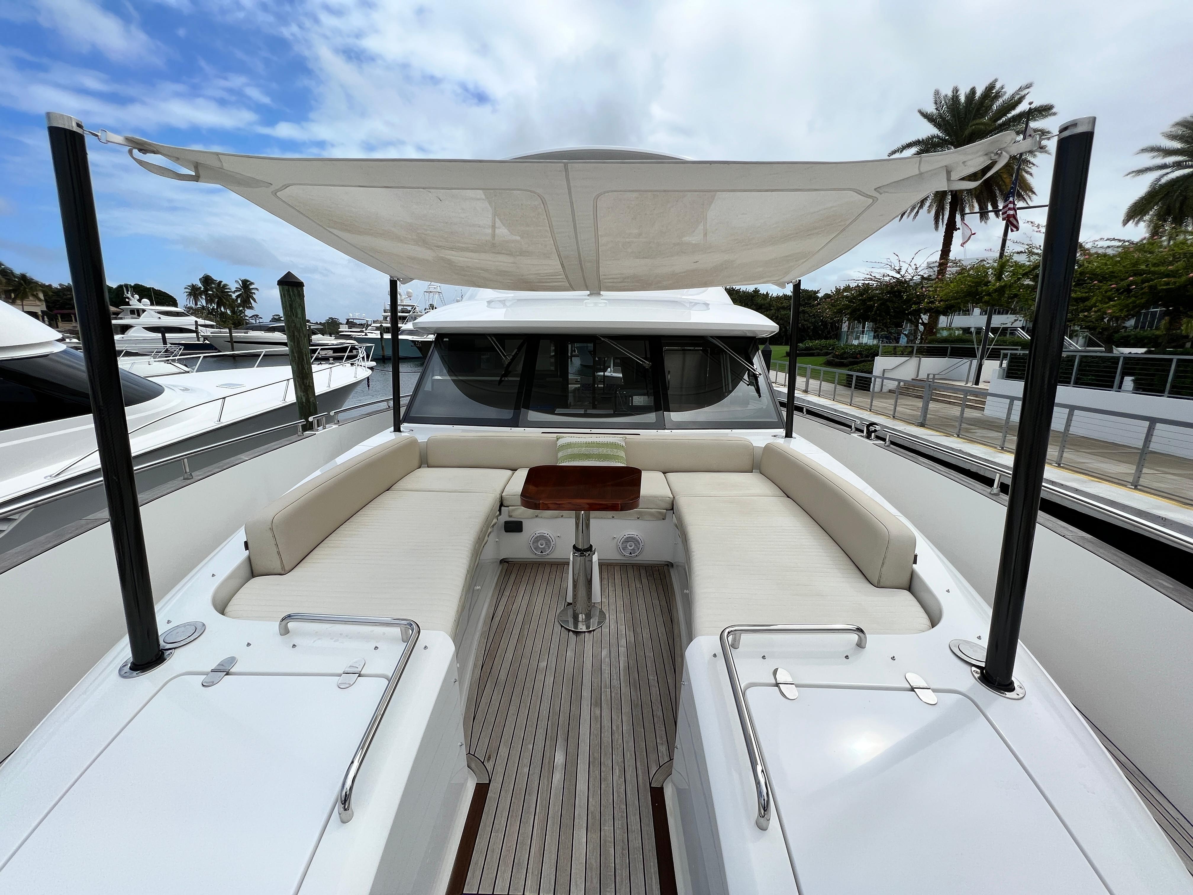 2017 Azimut Magellano yacht with spacious deck seating and canopy.