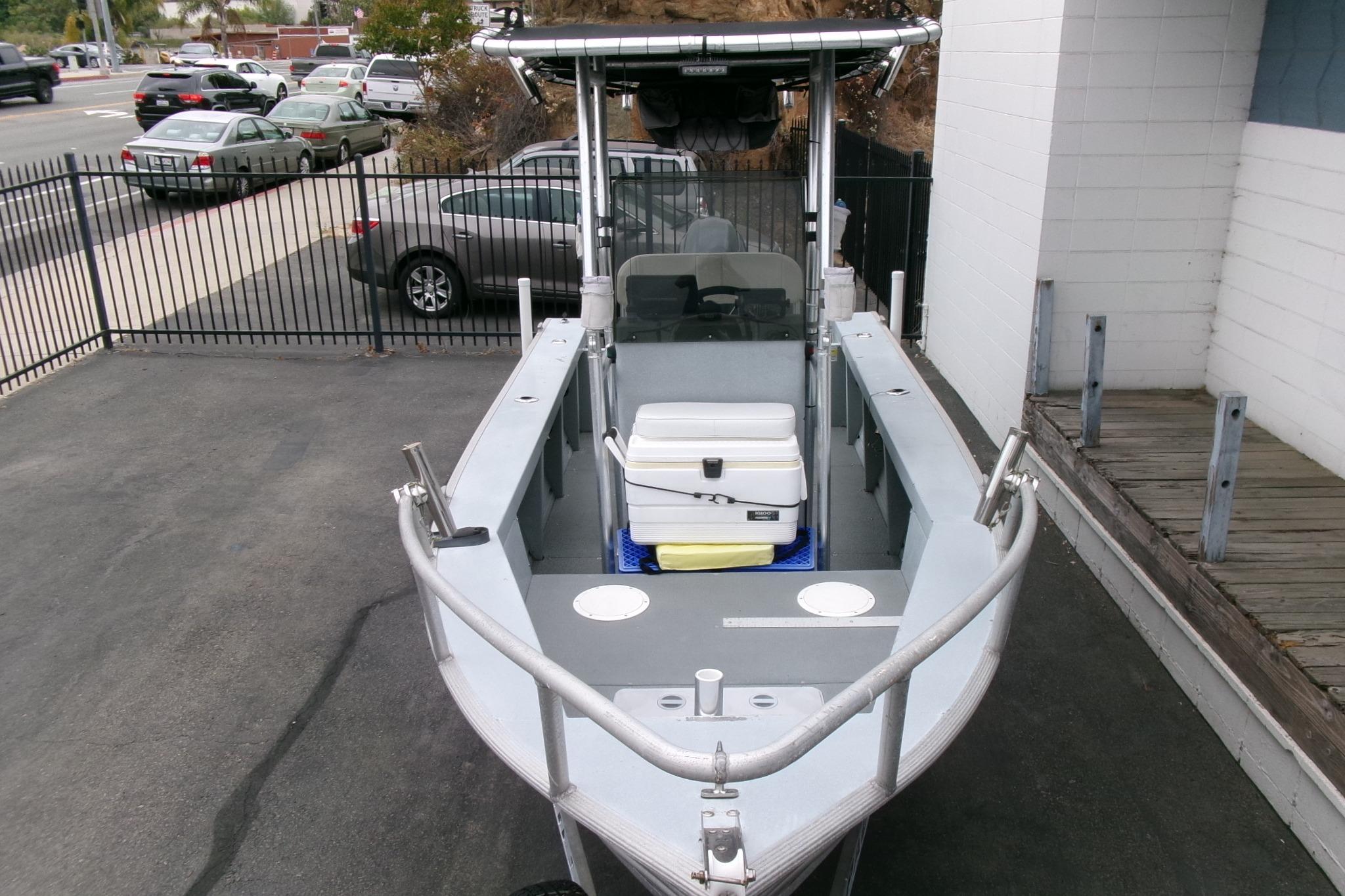 2017 Klamath Bayrunner 19 Baja boat parked, featuring a central console and storage cooler.