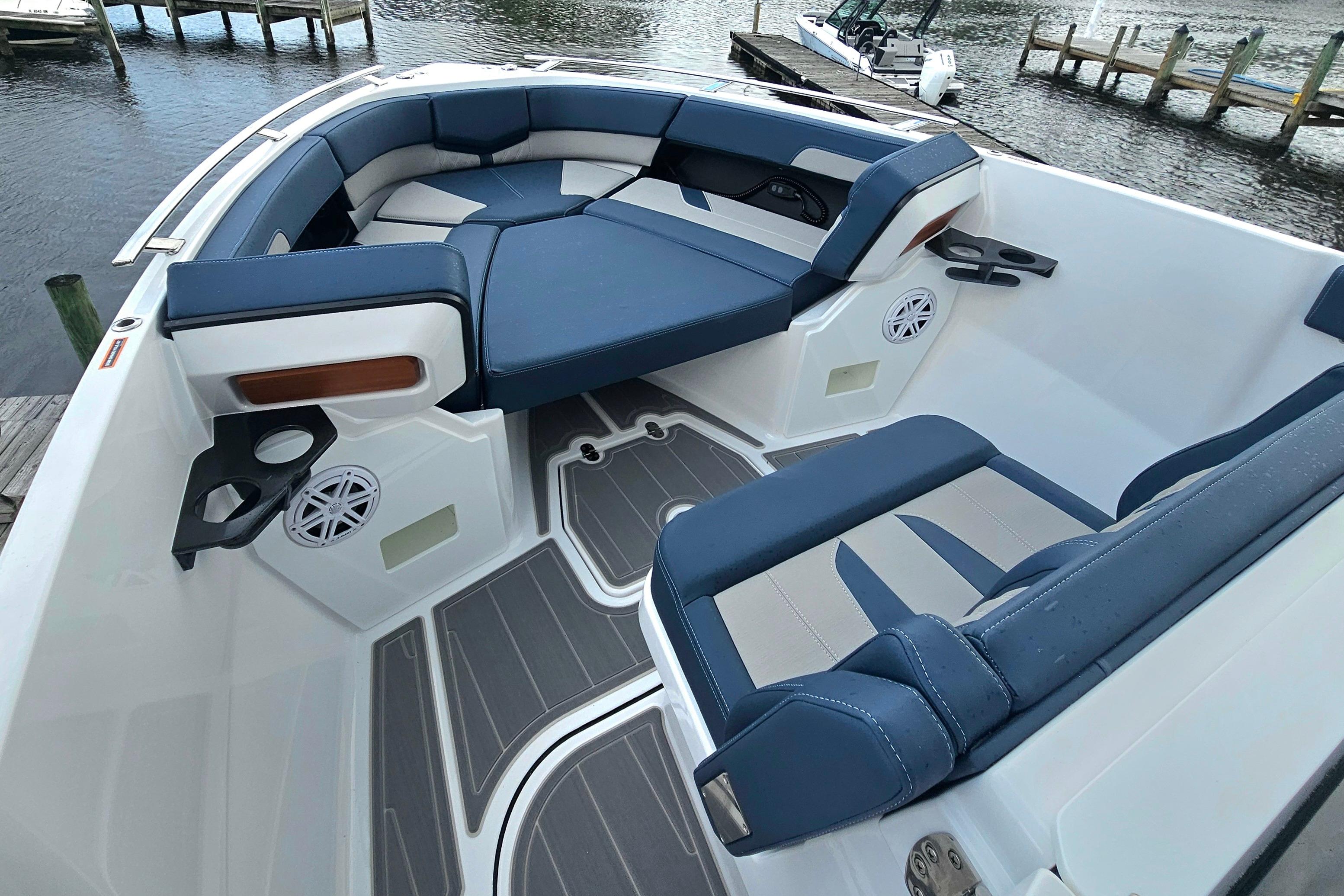 Luxurious seating on the 2026 Monterey Elite 27 OB boat, featuring sleek blue and white upholstery.