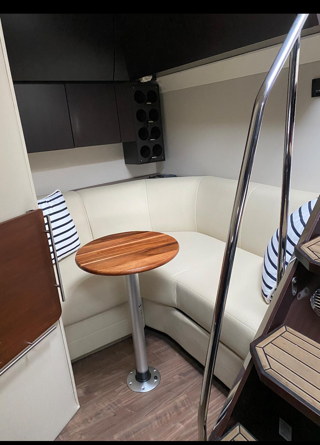 2017 Regal 53 Sport Coupe interior with cozy seating and wooden table.