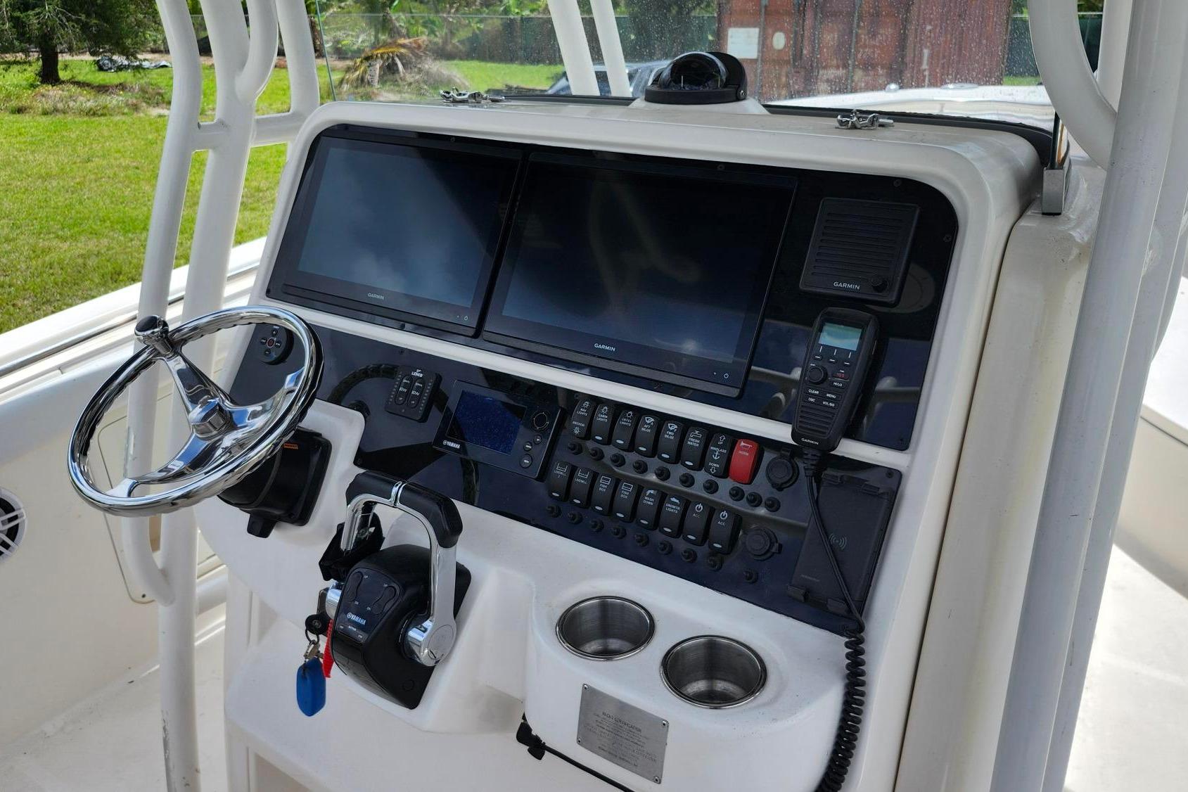 2015 Robalo R300 Center Console dashboard with steering wheel, dual screens, and control panel.
