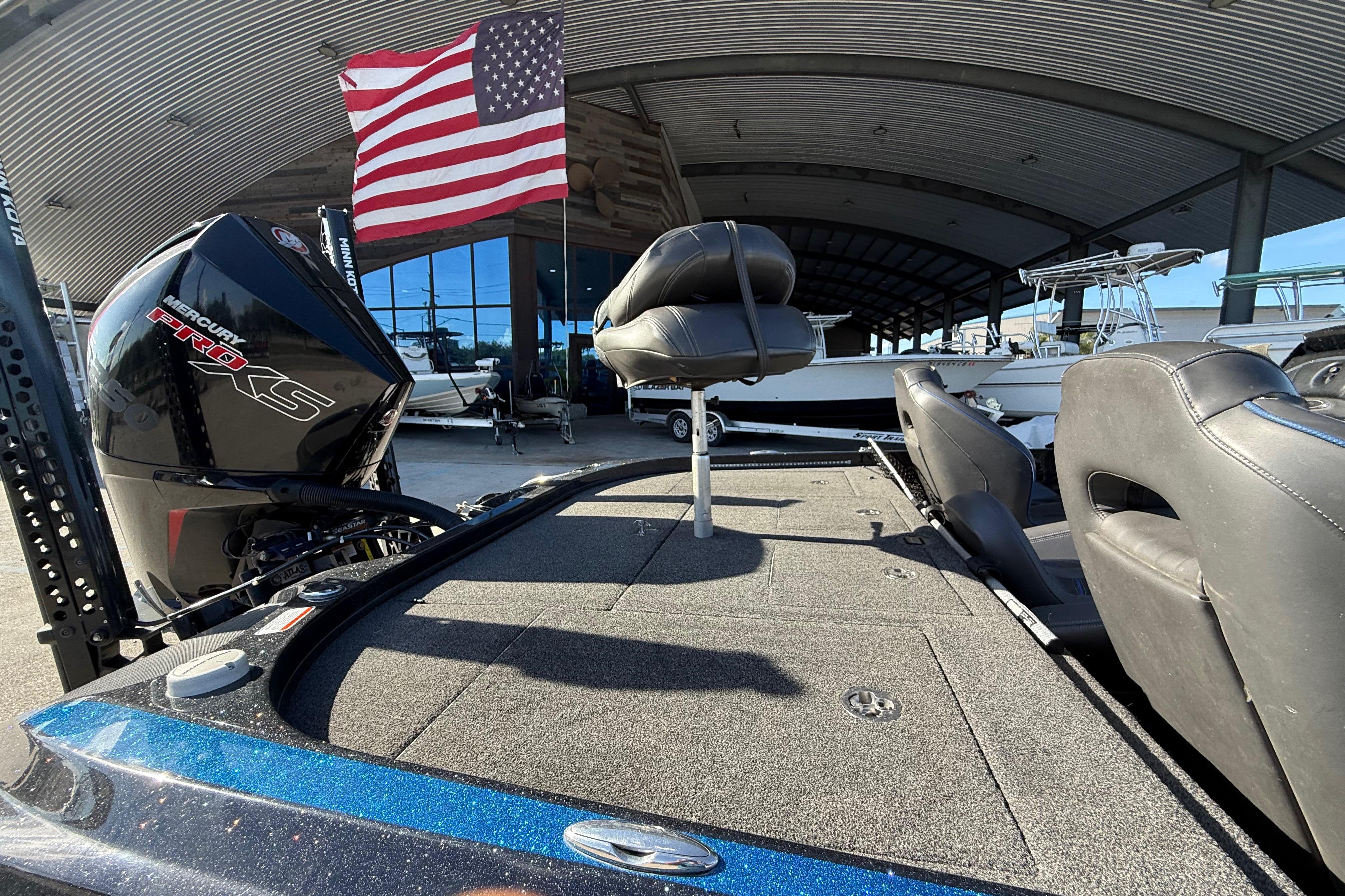 2018 Nitro Z21 boat with Mercury Pro XS engine, under American flag in marina.