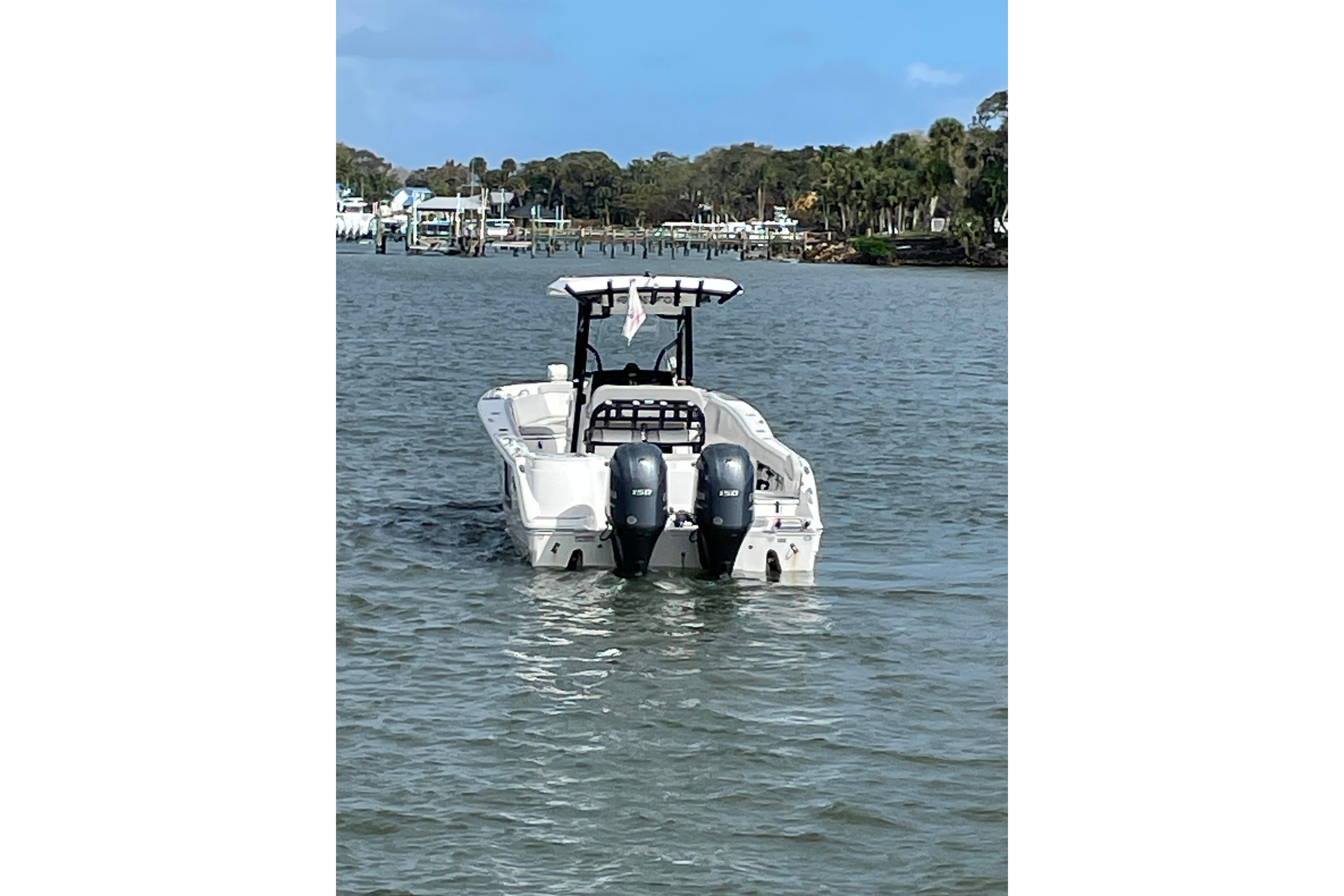 2023 Sea Fox 268 Commander boat on water with twin engines.