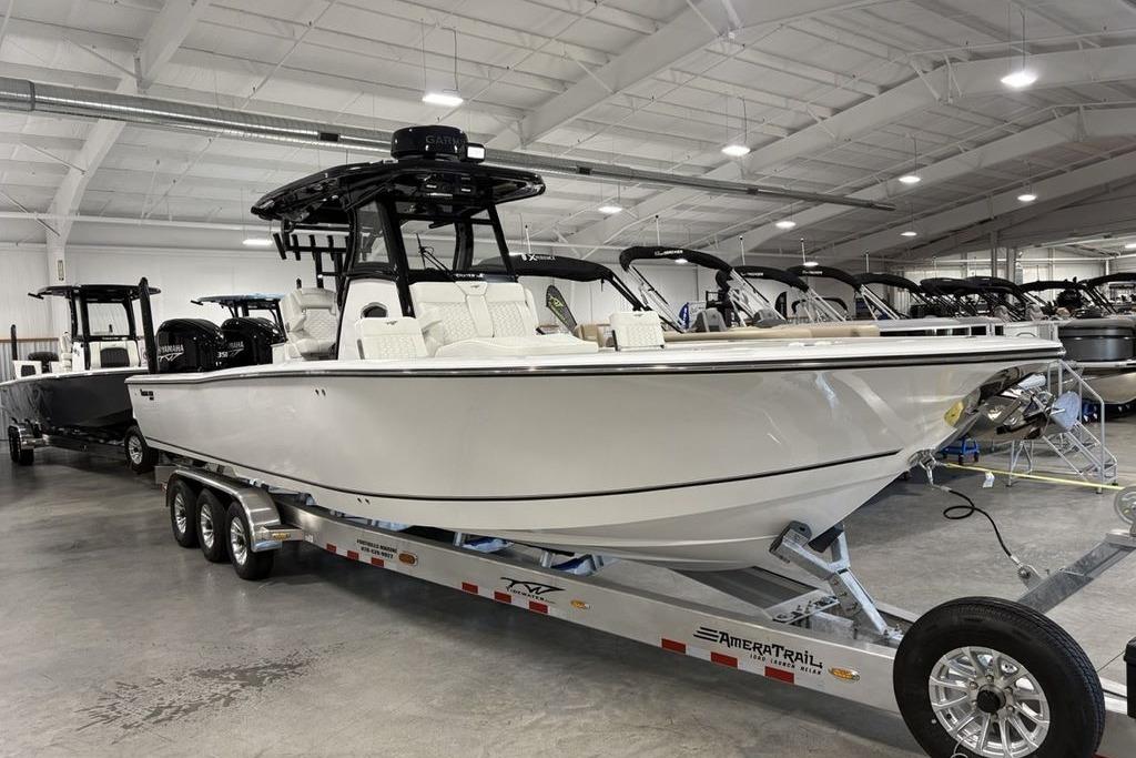 2026 Tidewater 3100 Carolina Bay boat on trailer in showroom.
