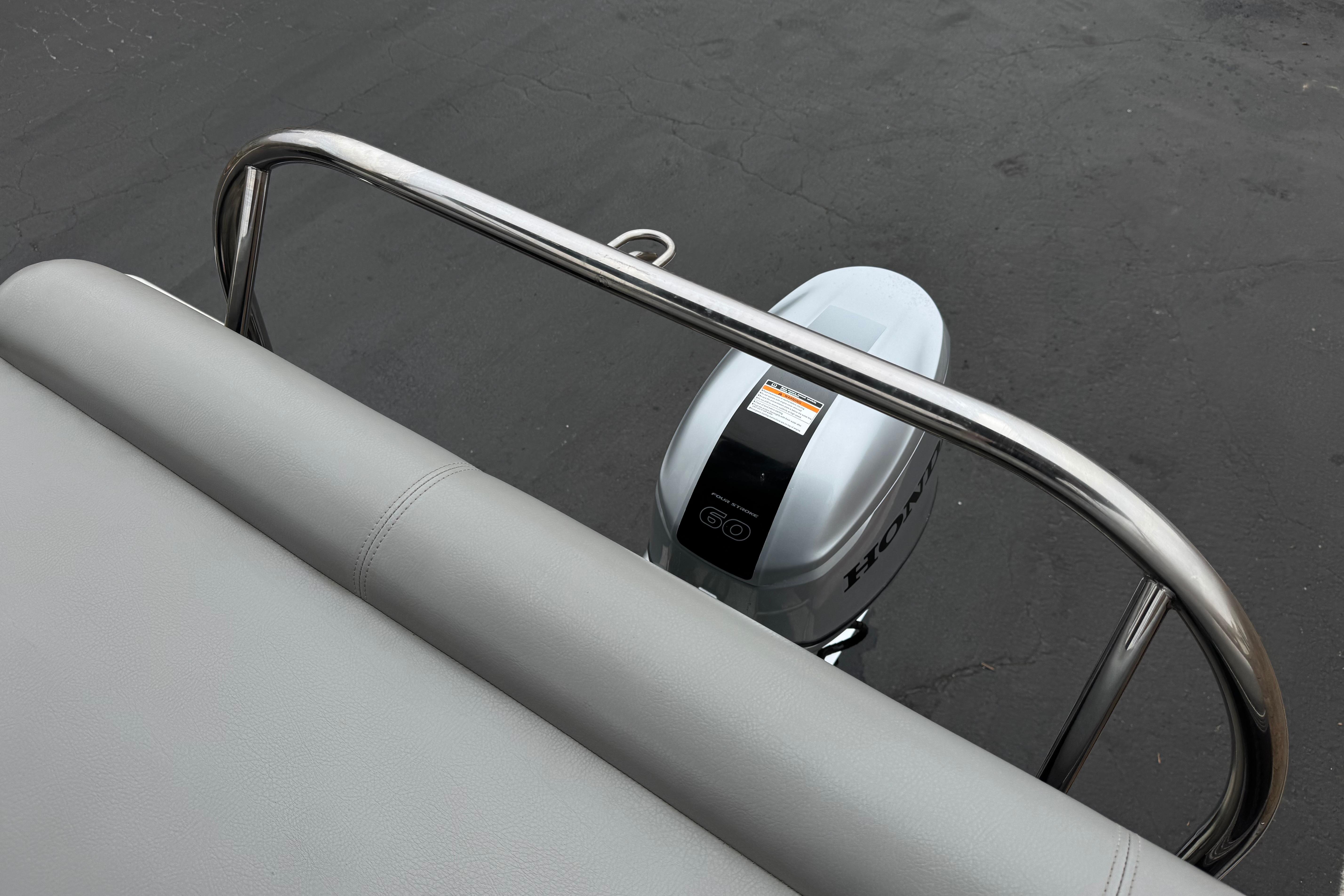 2020 Manitou 18 Aurora LE boat with Honda outboard motor, viewed from rear seat.
