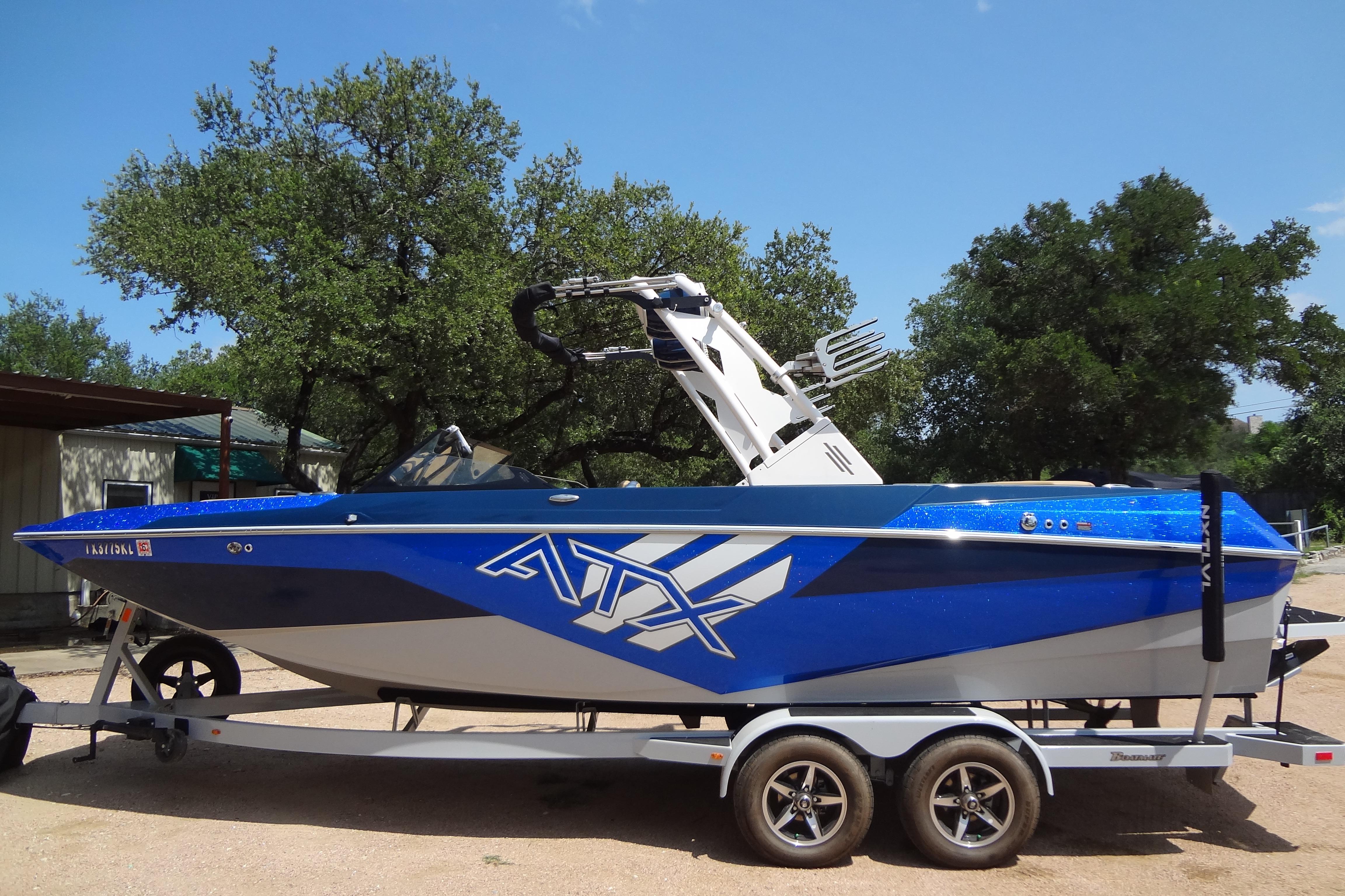 2022 ATX Surf Boats 24 Type-S in blue on trailer, parked outdoors.