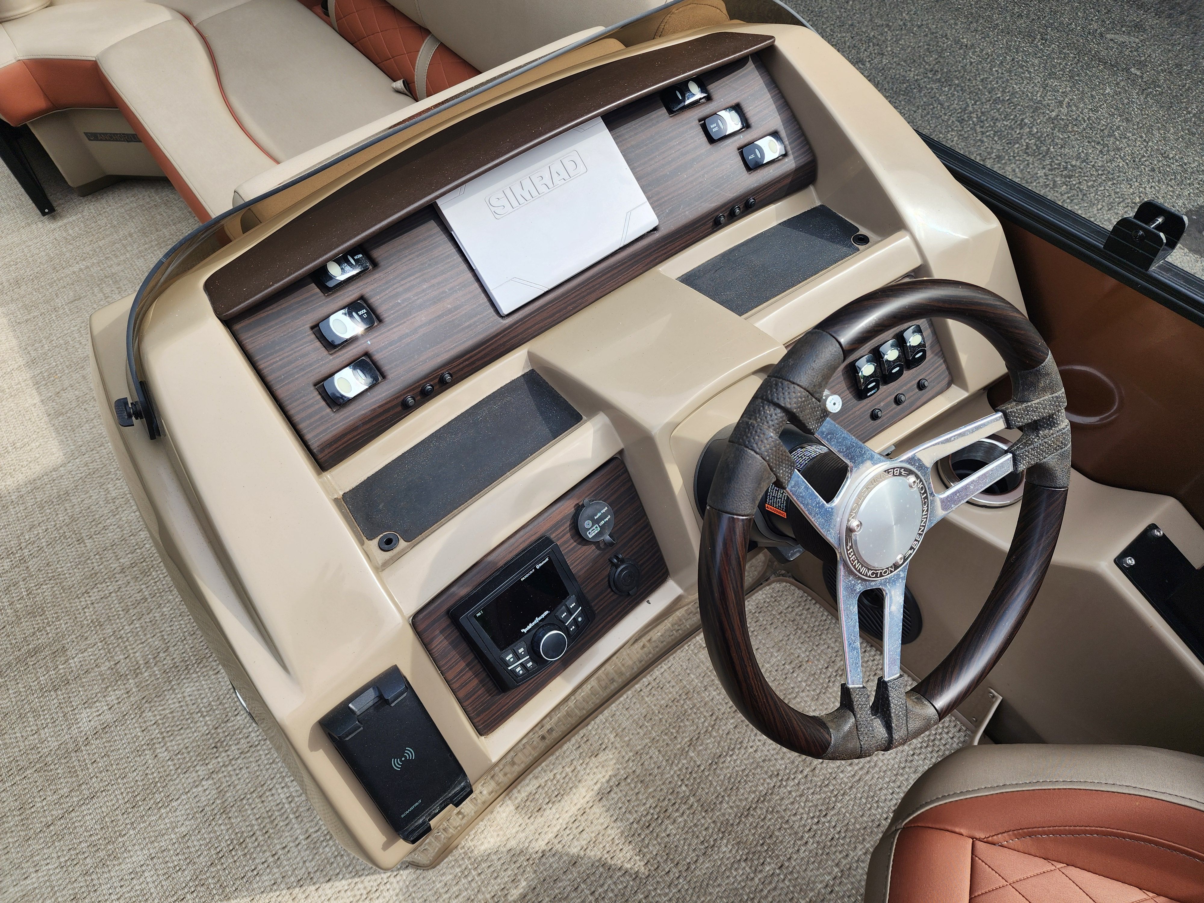 The image shows the helm of a Bennington 22 LSB boat with modern controls.