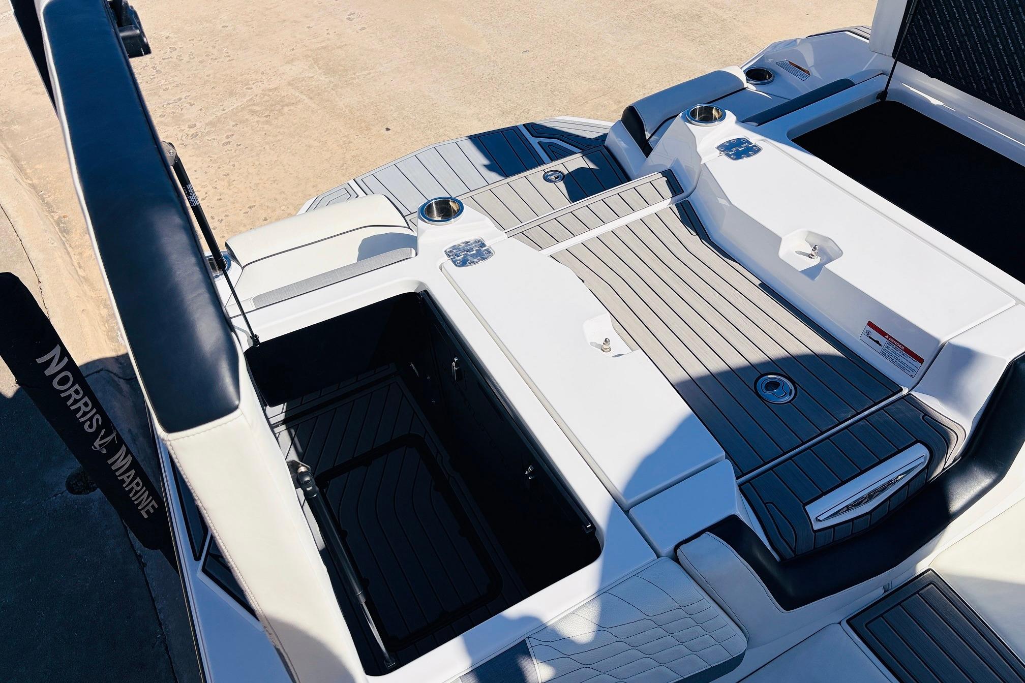 2023 Nautique Super Air Nautique G25 boat deck with storage compartments and seating.