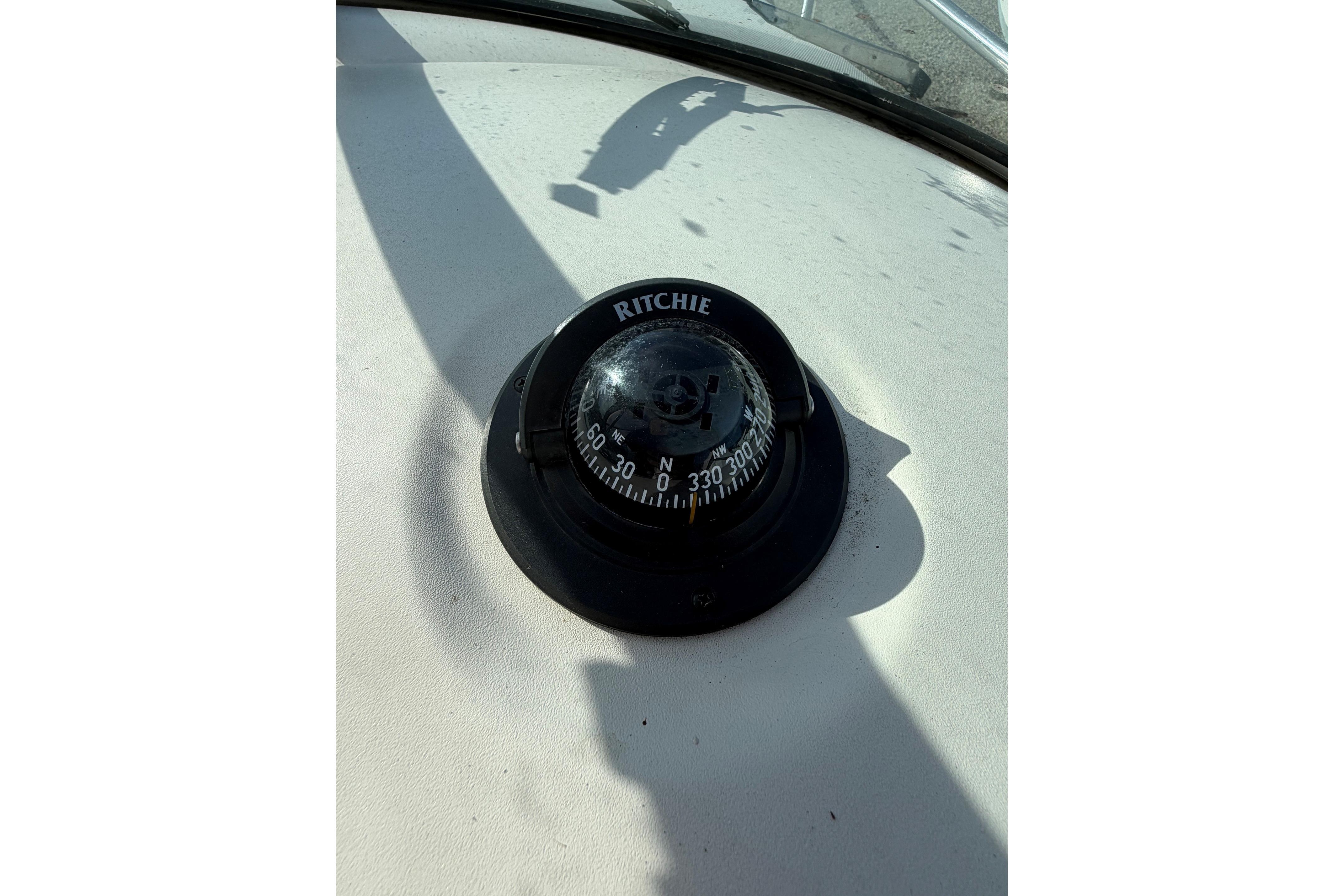Compass on 2000 Sea Ray 240 Sundancer boat dashboard, showing navigation details.