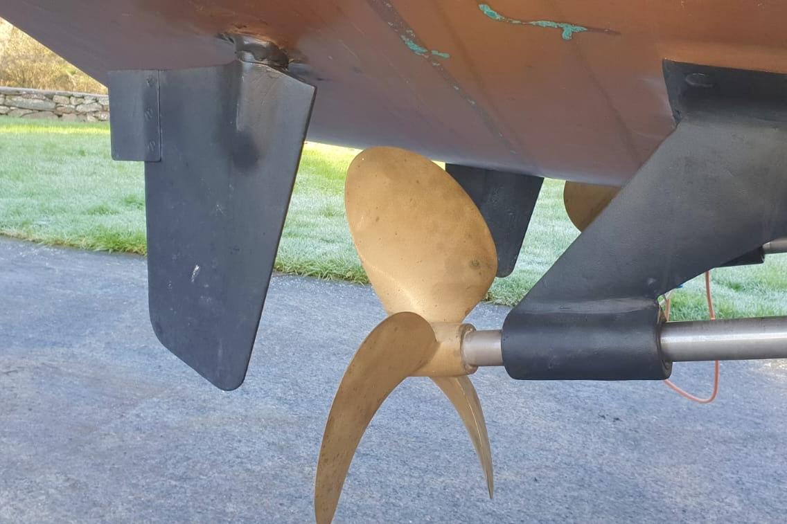 Propeller and rudder of 1989 Fairey Spearfish MKIII boat on dry land.