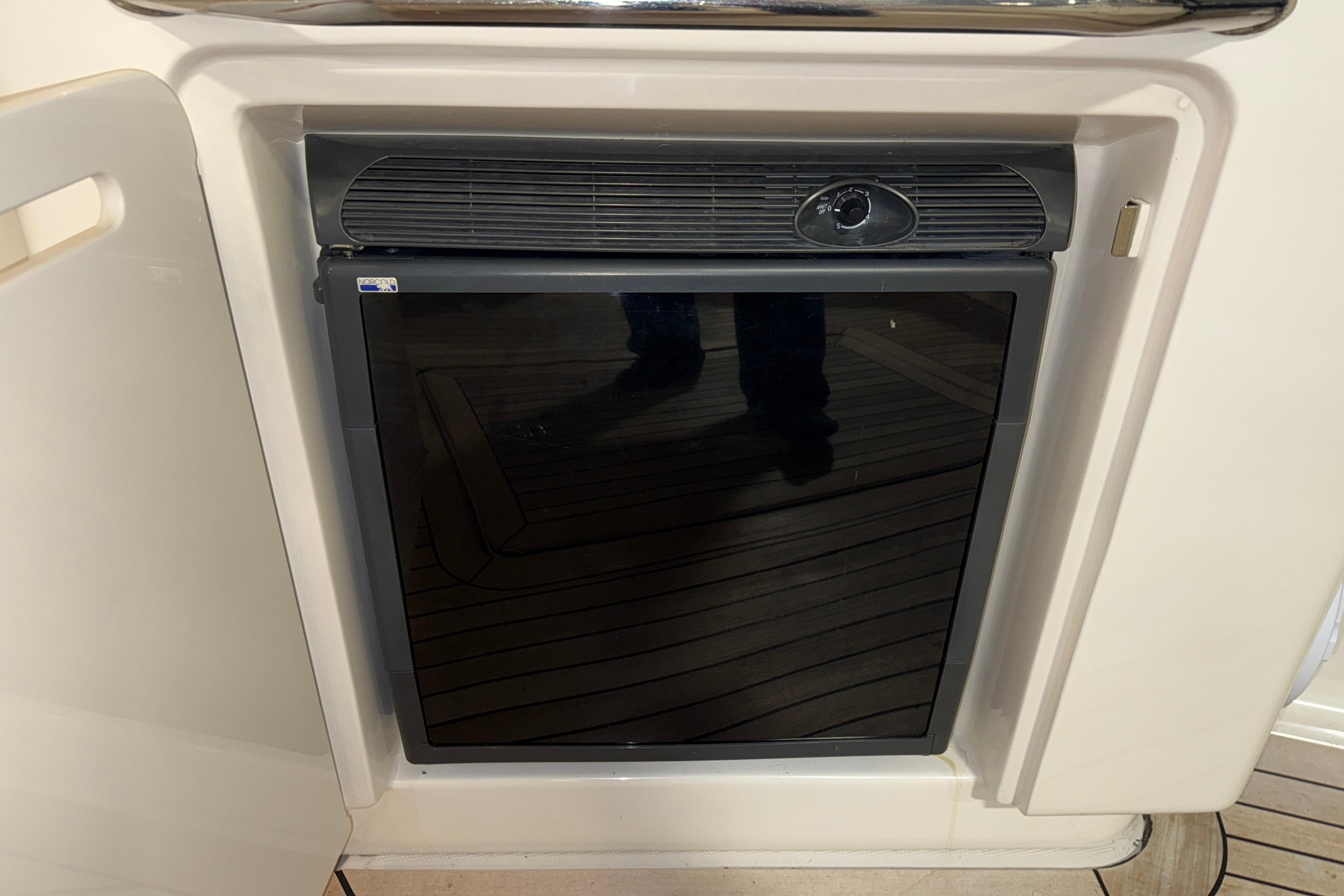 Built-in refrigerator on 2008 Sea Ray 55 Sundancer yacht, featuring sleek black door design.
