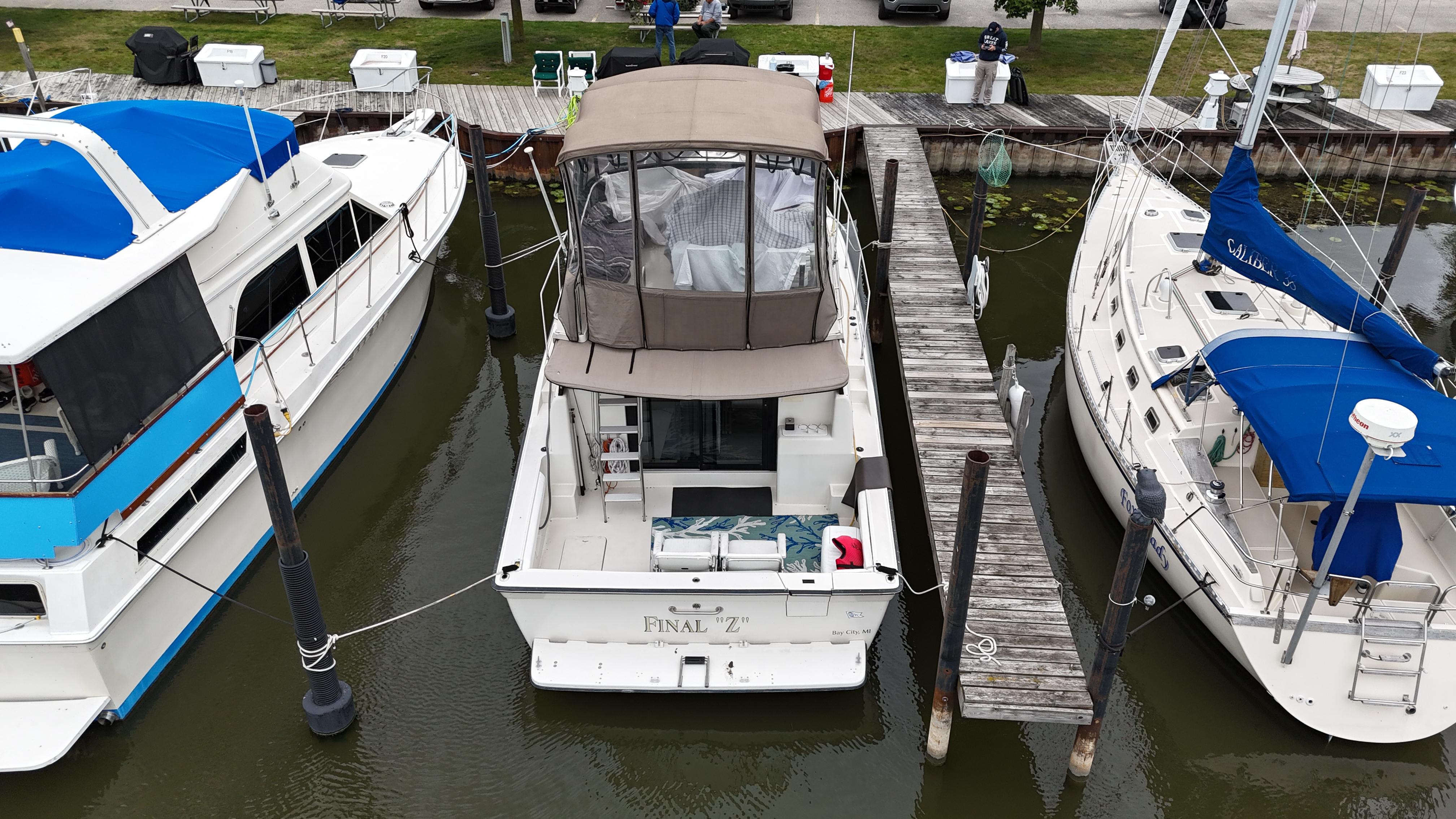Aerial view of a 1991 Silverton 37 Motor Yacht docked between two boats.