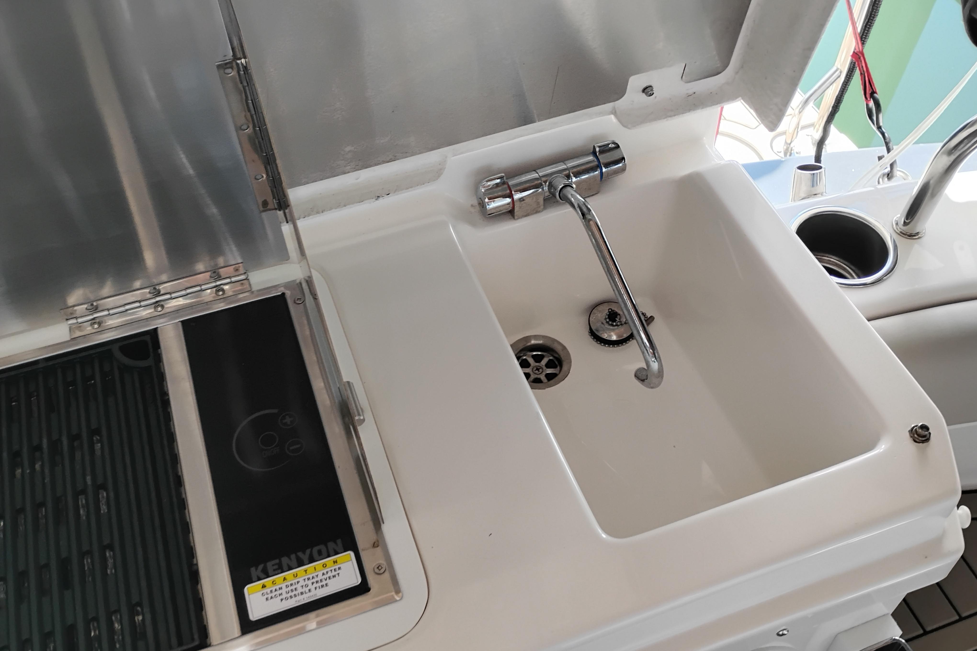 2022 Cutwater C-32 Coupe boat sink and grill area with Kenyon appliance.