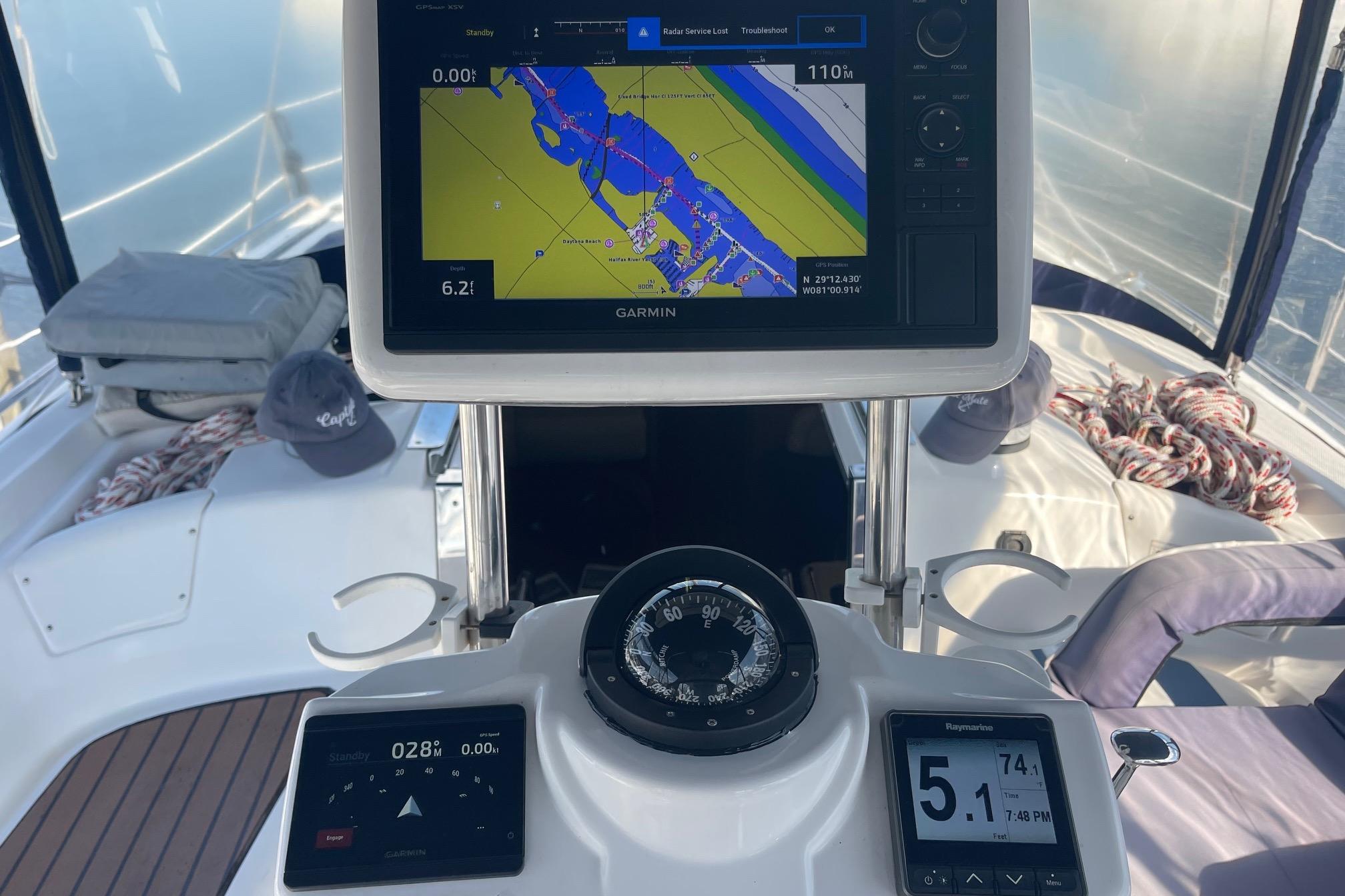 Hunter 45 Center Cockpit 2010 yacht helm with Garmin navigation display and compass.