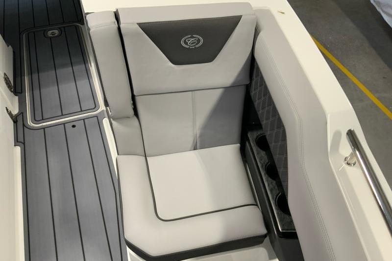 2026 Cobalt R31 boat interior with gray cushioned seating and cup holders.