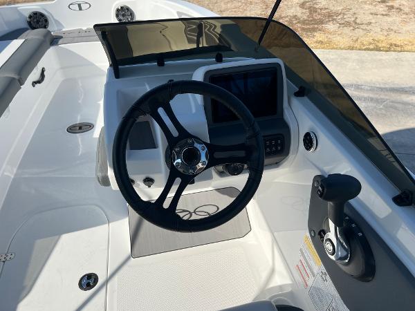 2024 Tahoe T21 boat cockpit with steering wheel and control panel.