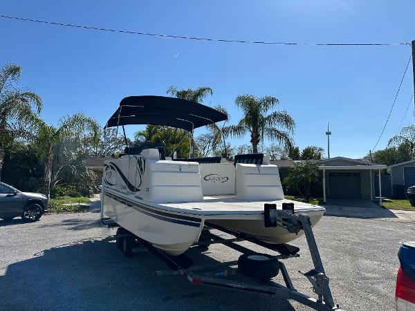 2020 Beachcat 20 boat on trailer, parked outdoors with palm trees in the background.