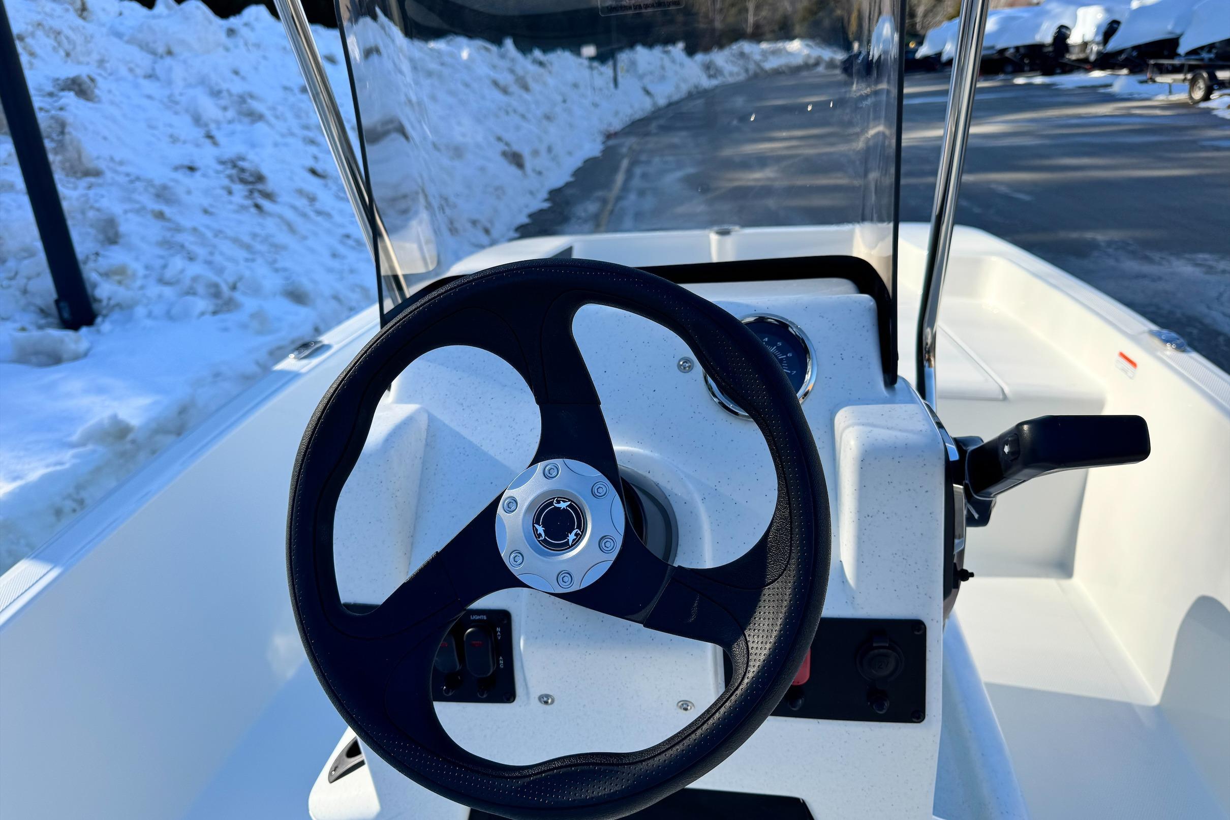 2026 Mako Pro Skiff 15 CC steering console with snow-covered background.