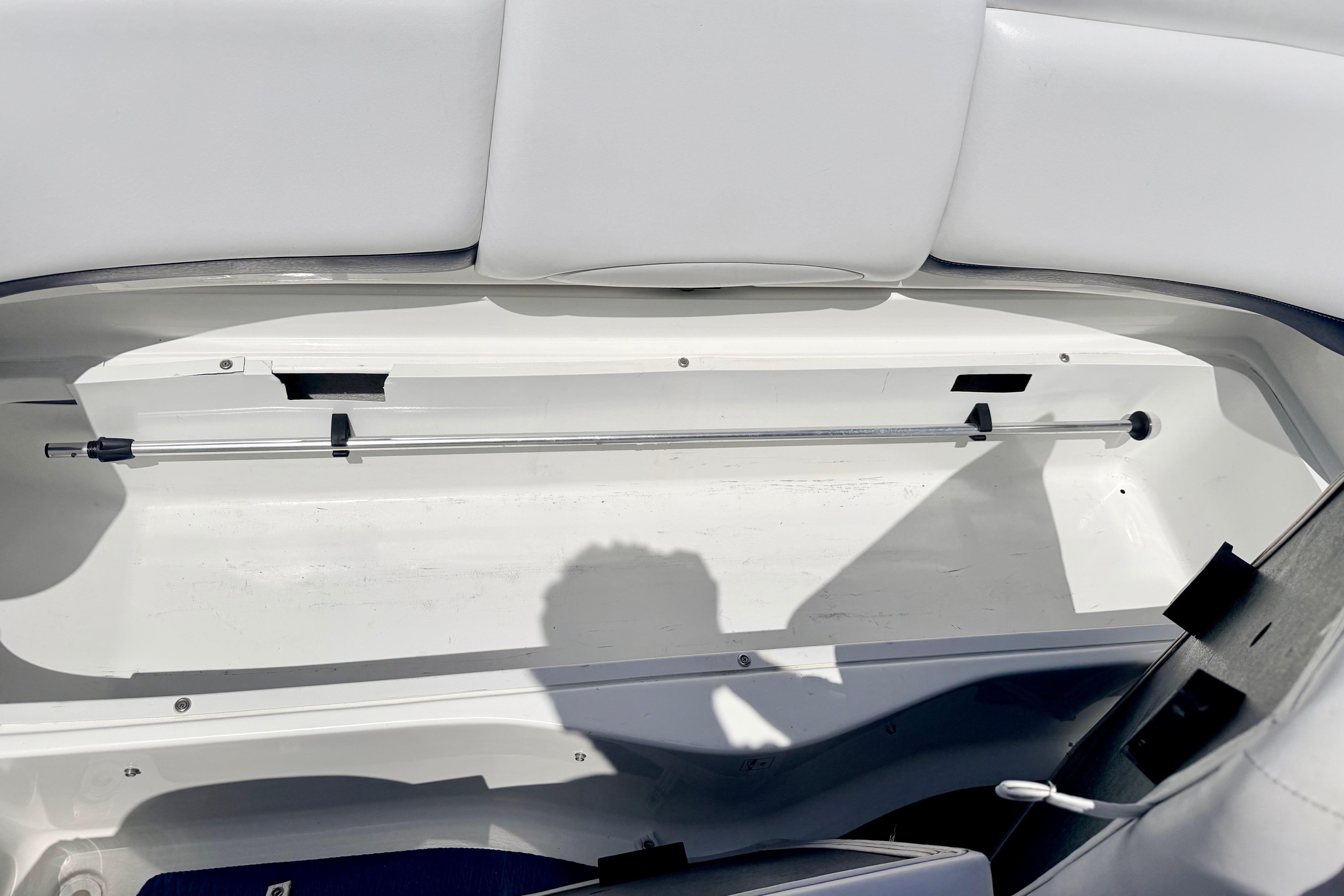 2004 Bombardier SEADOO Utopia 185 storage compartment with white interior and hydraulic support rod.