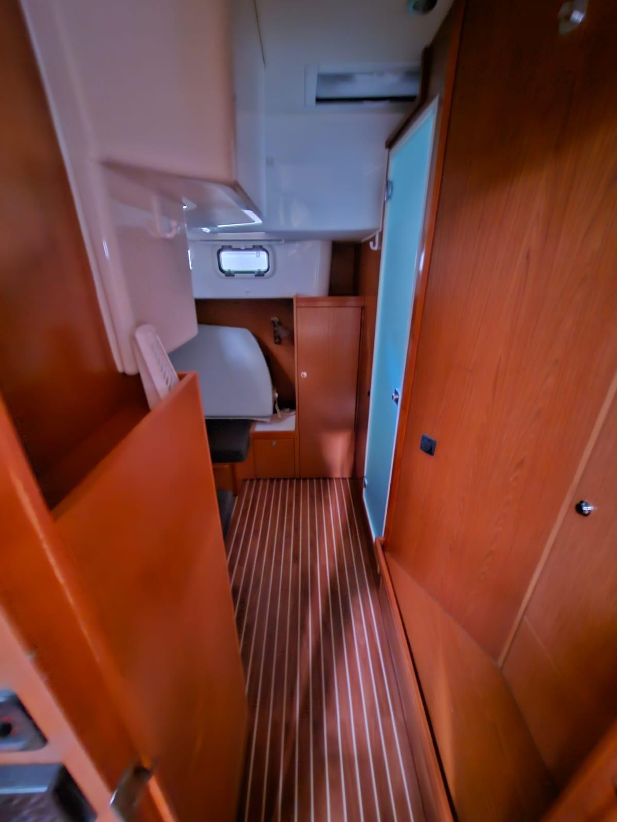 Interior of 2013 Bavaria 38 HT Sport yacht with wooden flooring and compact design.
