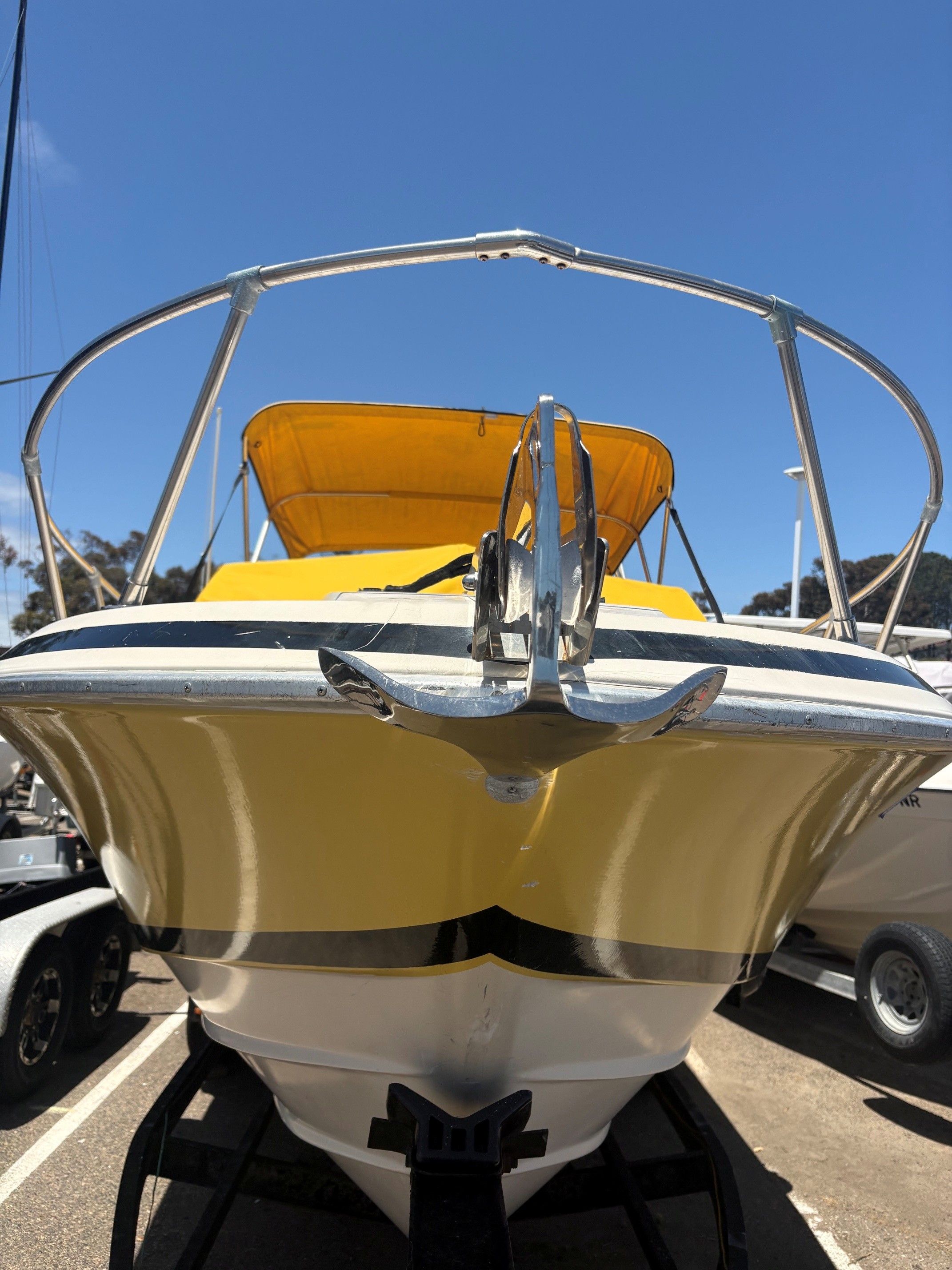 Yellow 1979 Wellcraft Nova 250 boat with anchor, front view.