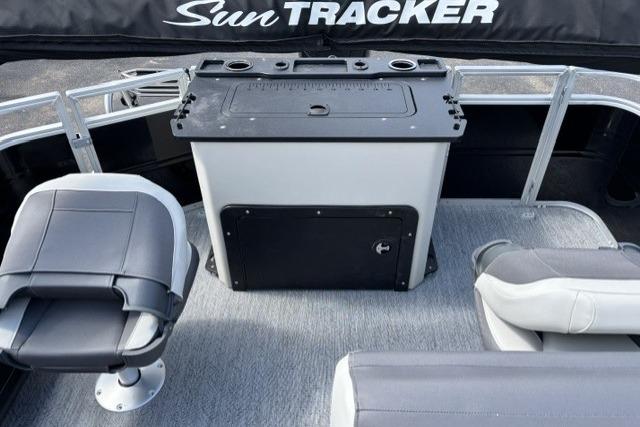 2026 Sun Tracker Fishin' Barge 22 DLX interior with seating and storage console.
