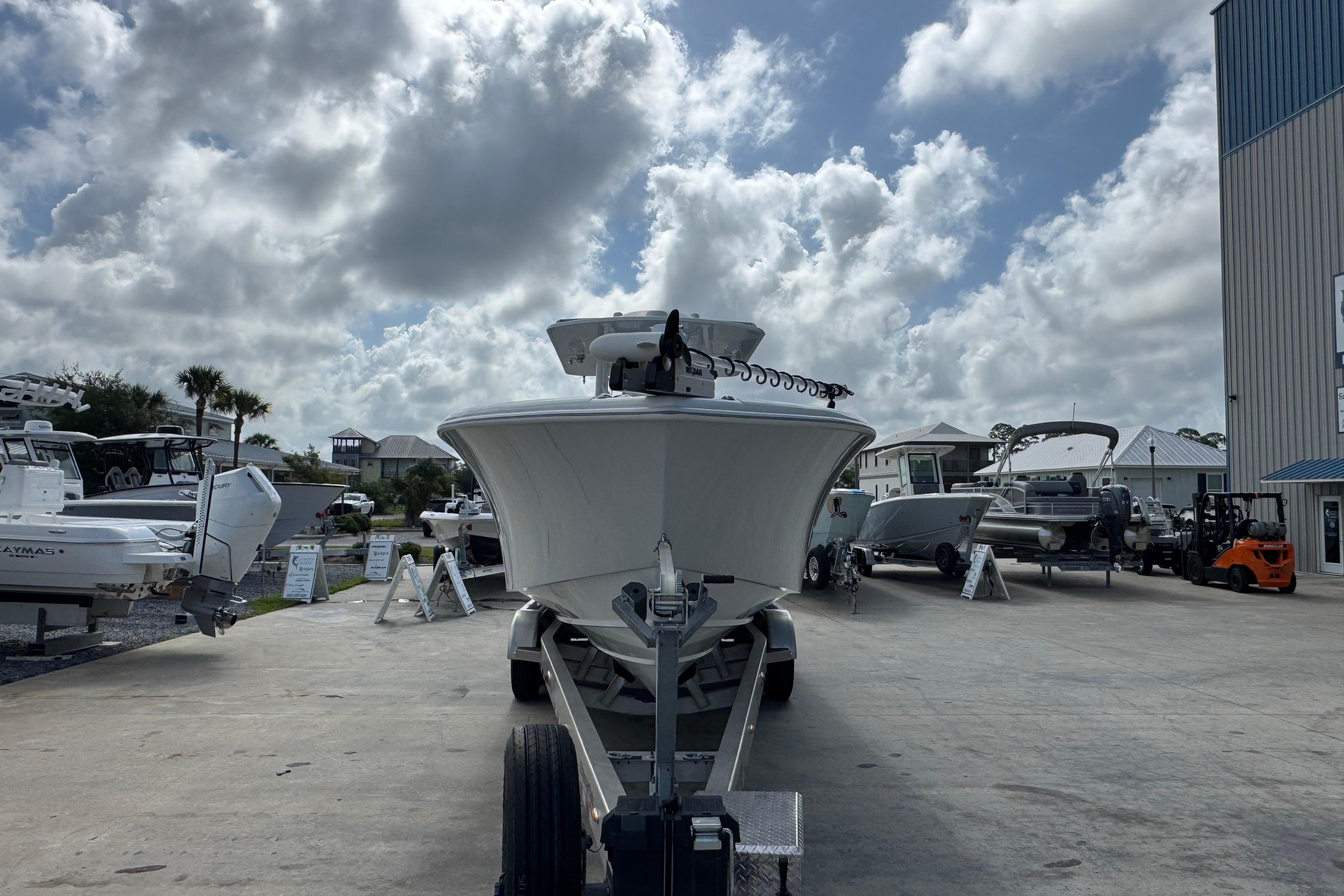 2022 Yellowfin 32 Offshore boat on trailer under cloudy sky at marina.
