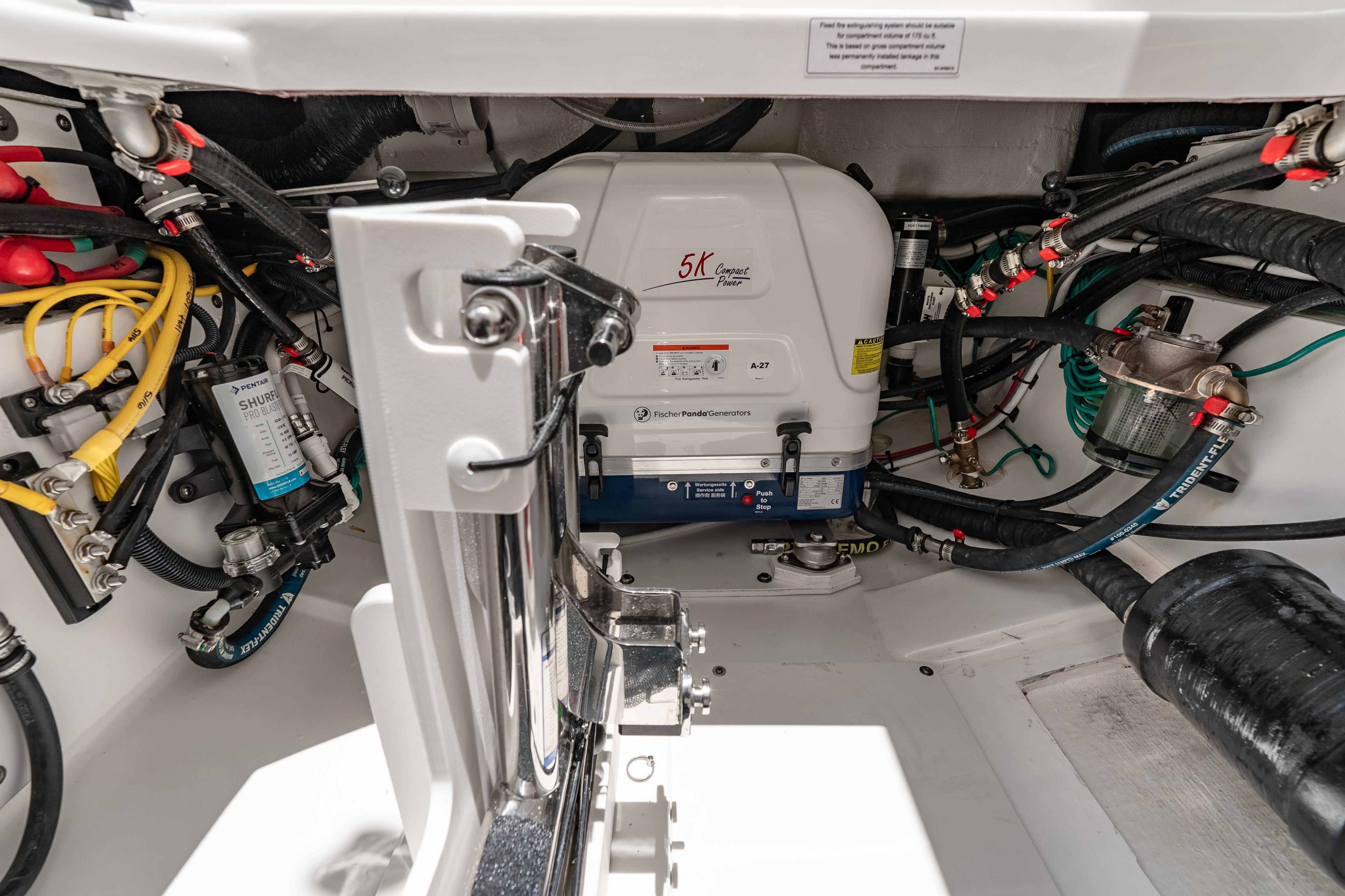Engine compartment of 2026 Pursuit DC 326 Dual Console with generator and wiring.