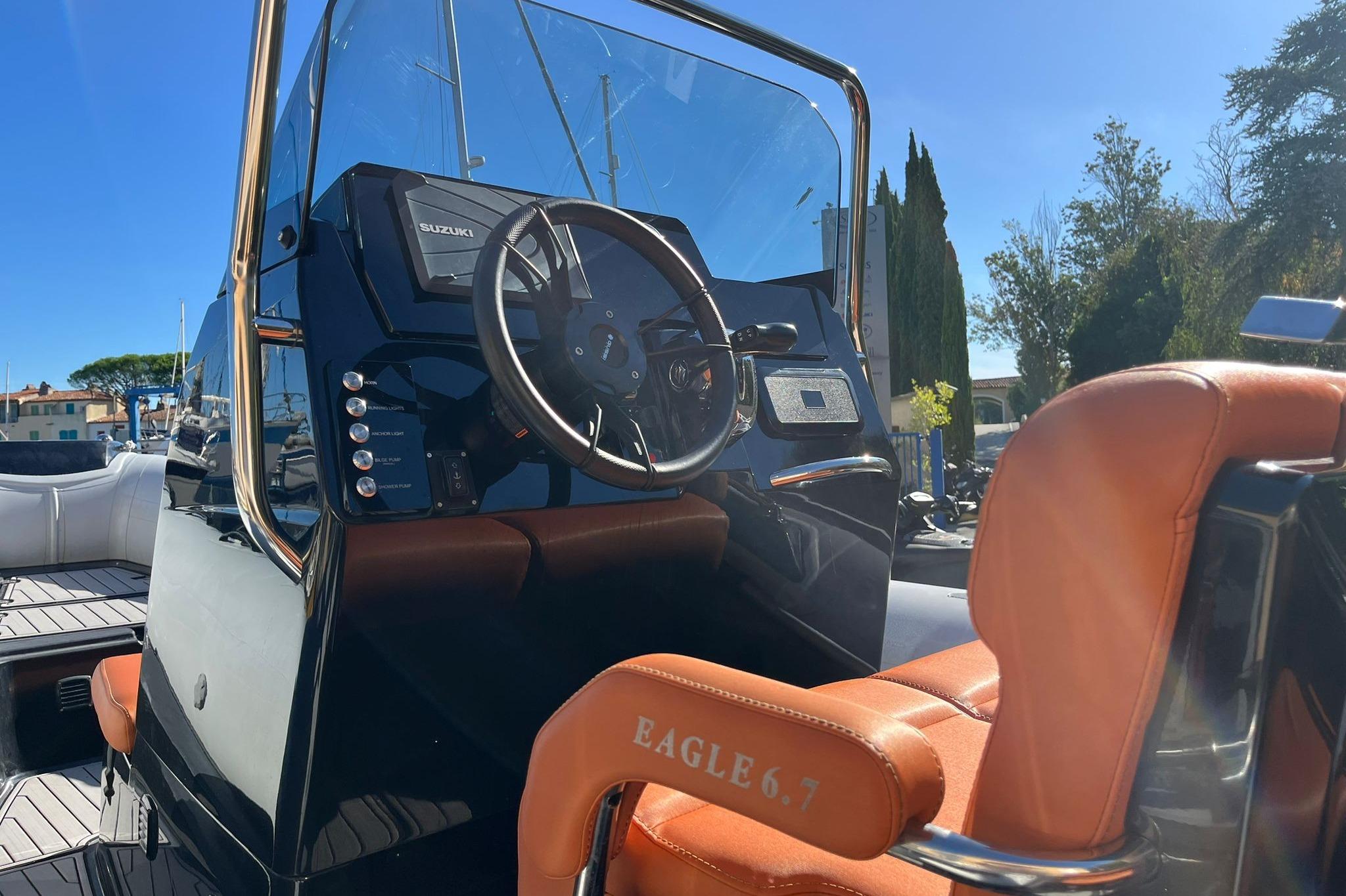 2022 Brig Eagle 6.7 boat cockpit with steering wheel and leather seating.