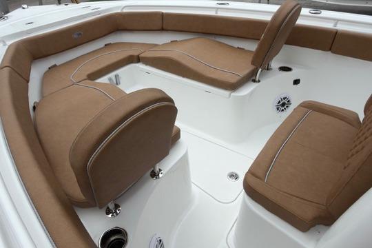 Luxurious seating on 2026 Sea Hunt Ultra 255 SE boat, featuring brown cushions and white deck.