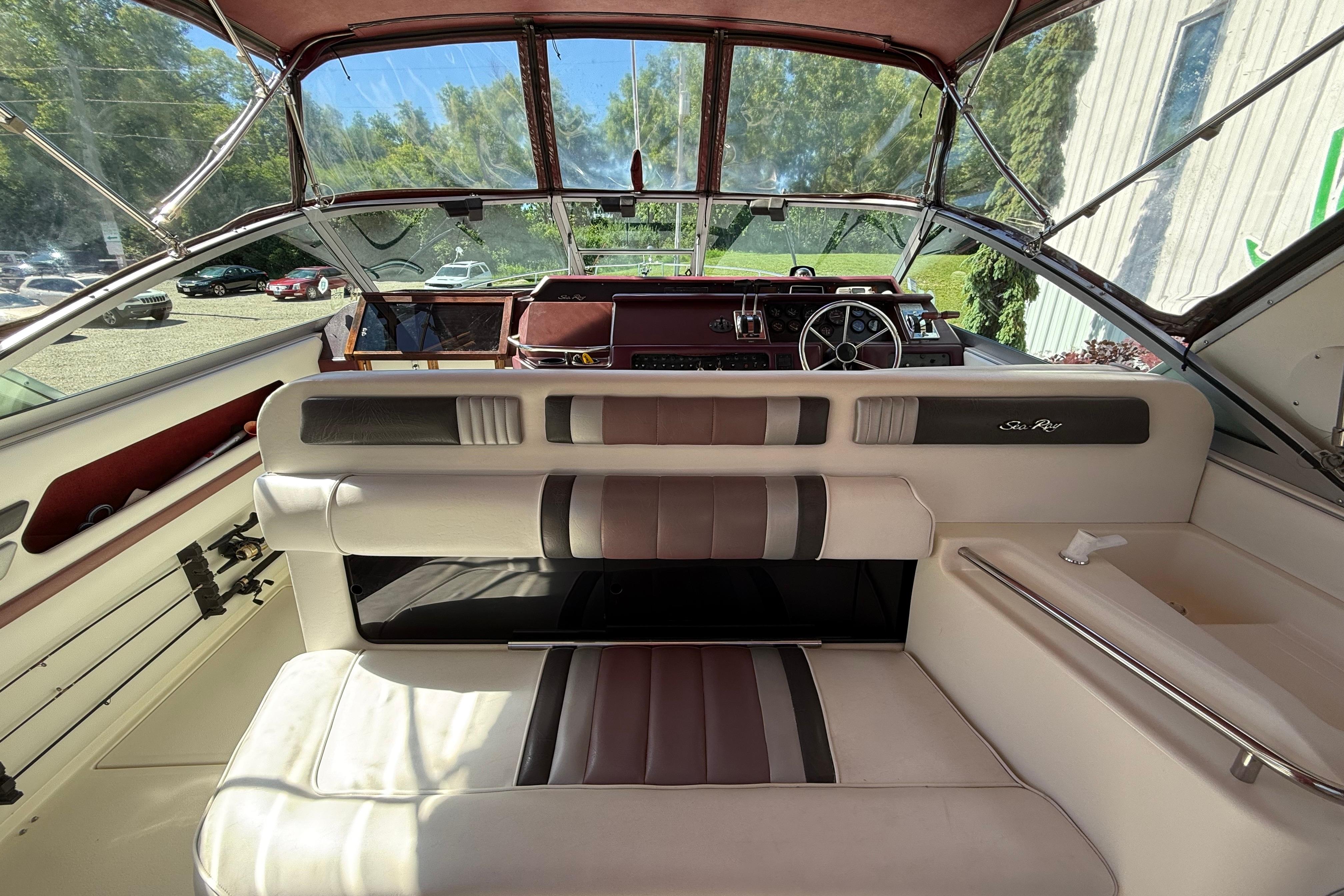 Interior of 1990 Sea Ray 310 Express Cruiser with leather seating and dashboard view.