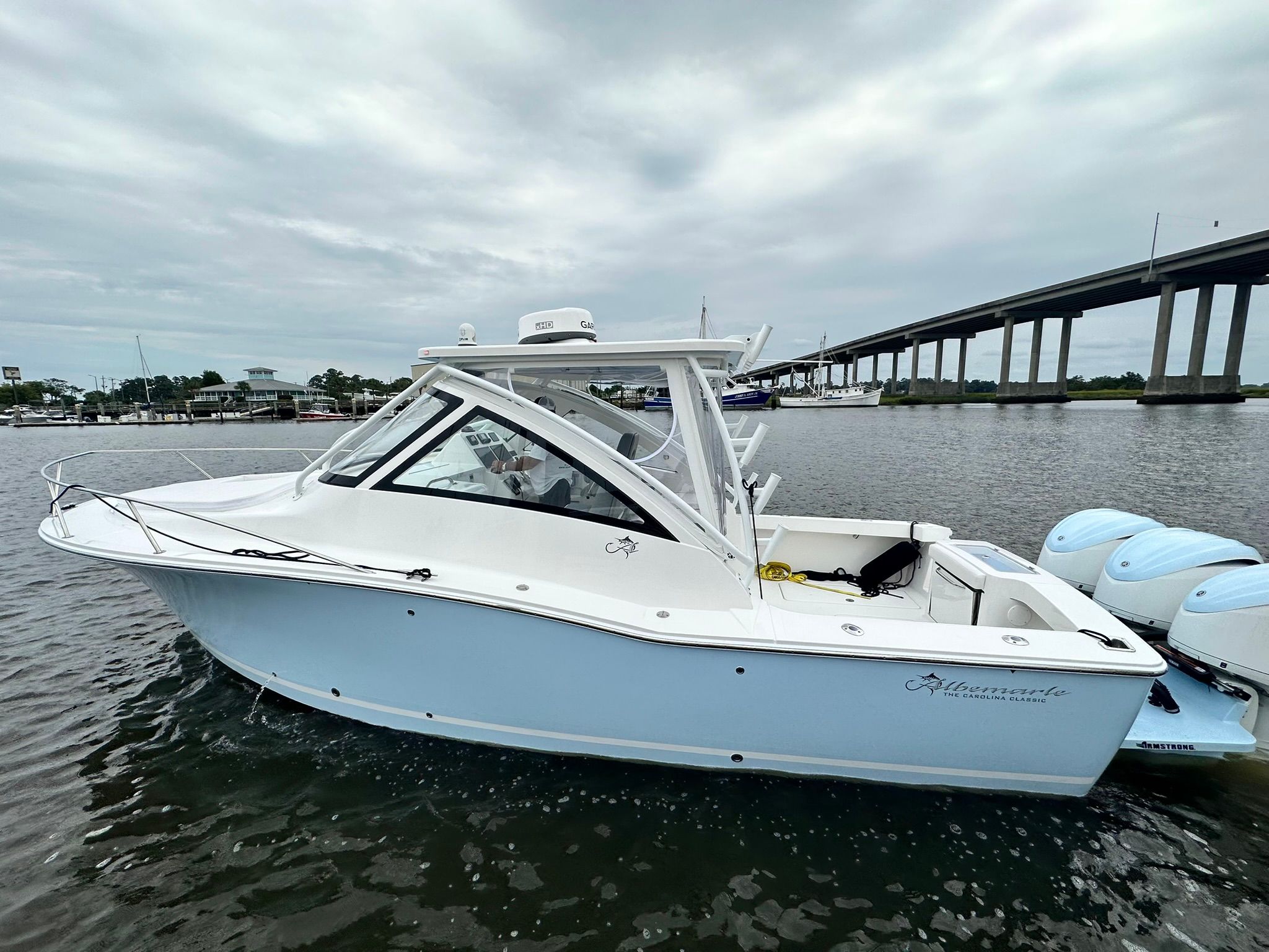 A 2024 Albemarle 30 Express boat on the water, featuring twin outboard engines.