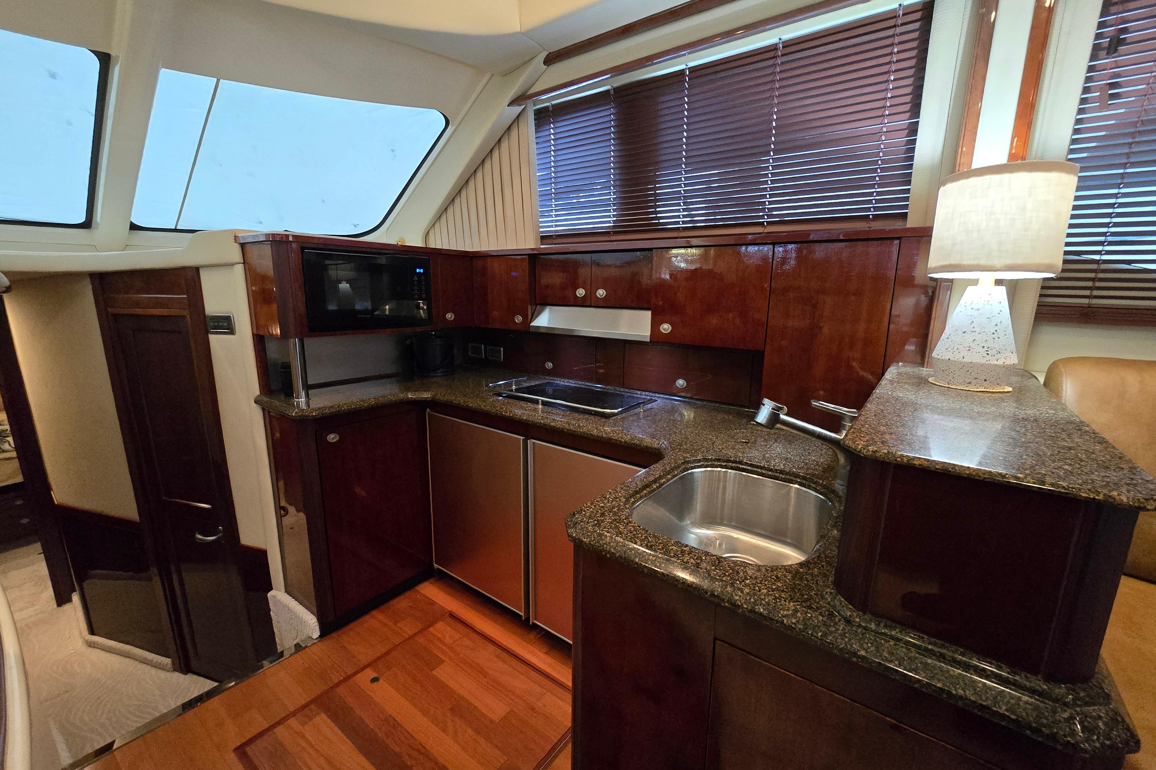 Luxurious kitchen interior of 2007 Sea Ray 52 Sedan Bridge yacht with modern amenities.