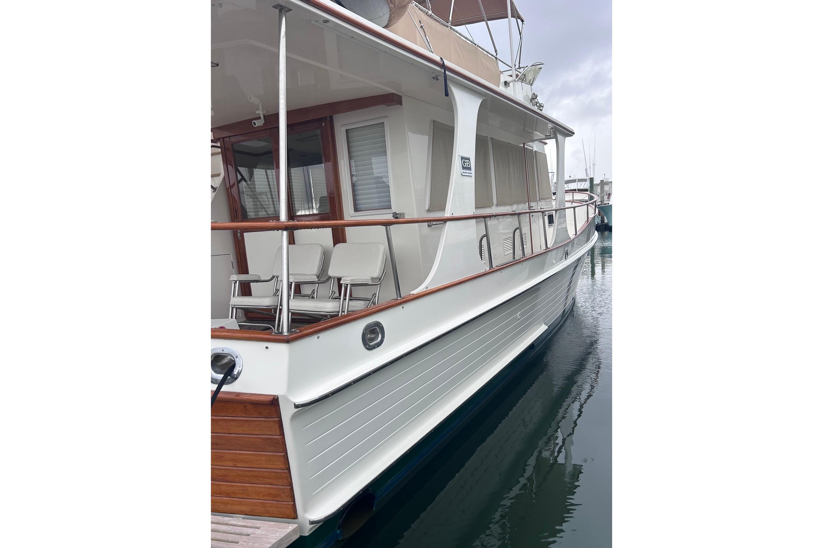 1999 Grand Banks 42 Europa yacht docked, showcasing elegant design and wooden accents.