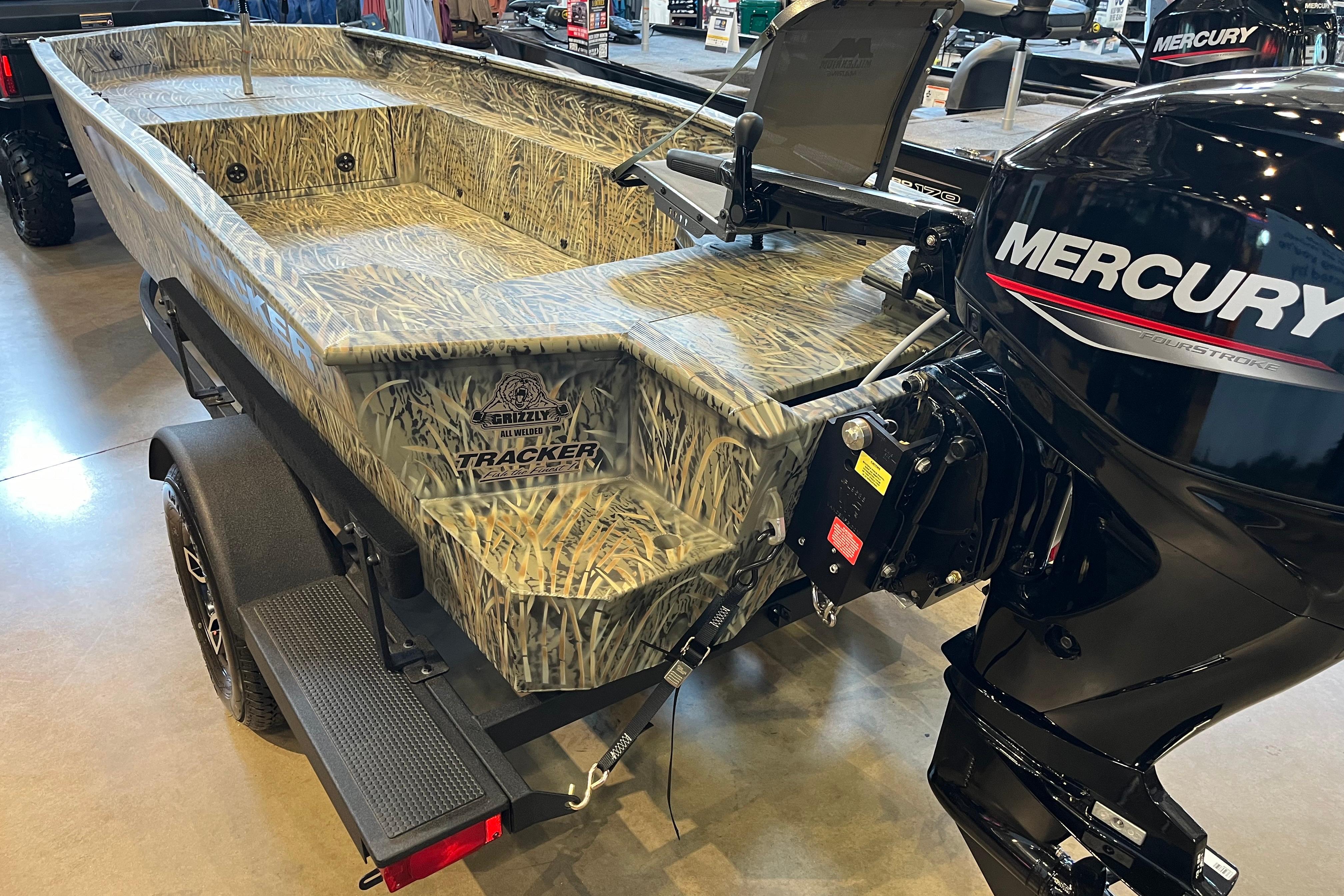 2026 Tracker Grizzly 1654 T Sportsman boat with camo design and Mercury outboard motor.