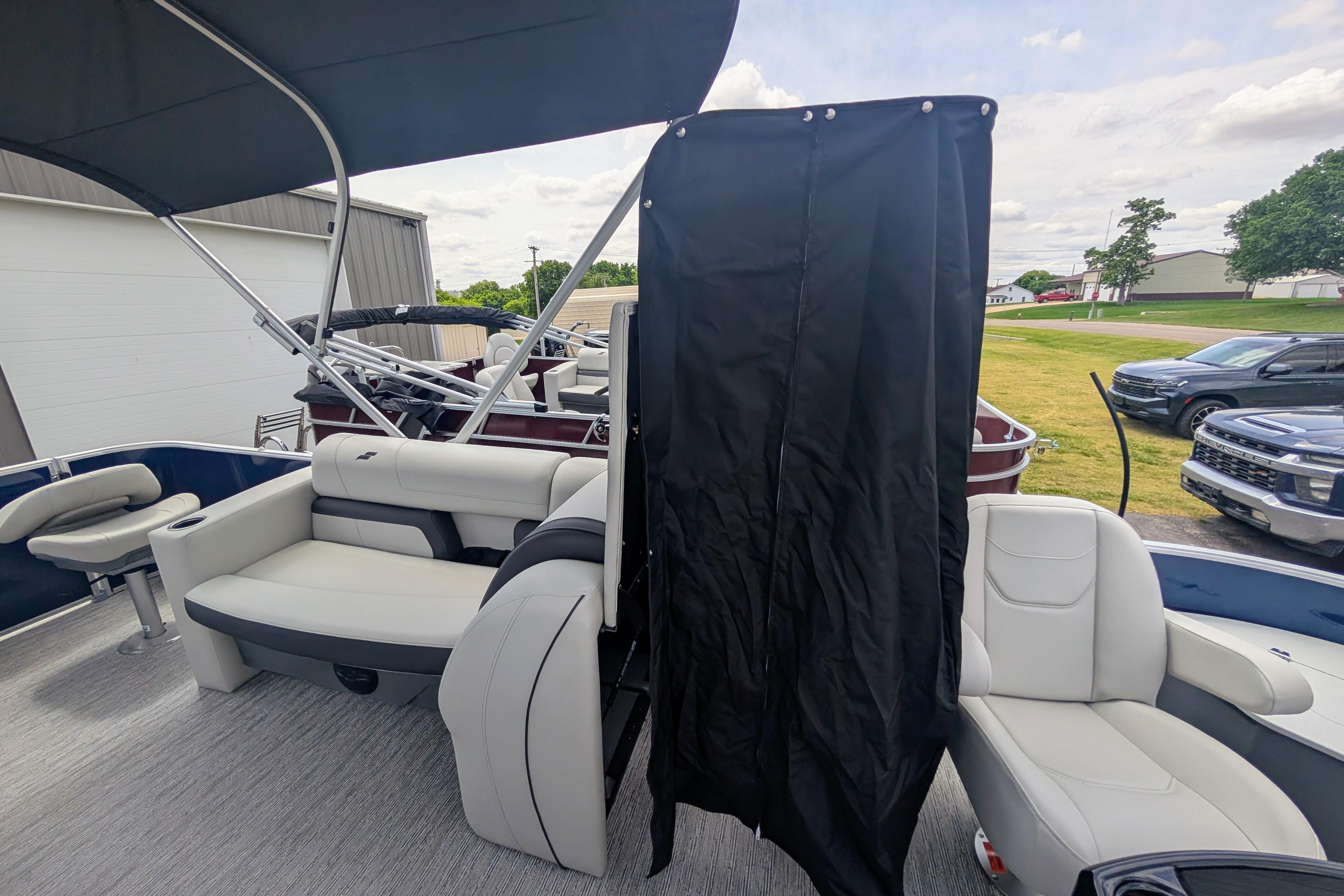2026 Starcraft EX 20 F pontoon boat interior with seating and privacy curtain.