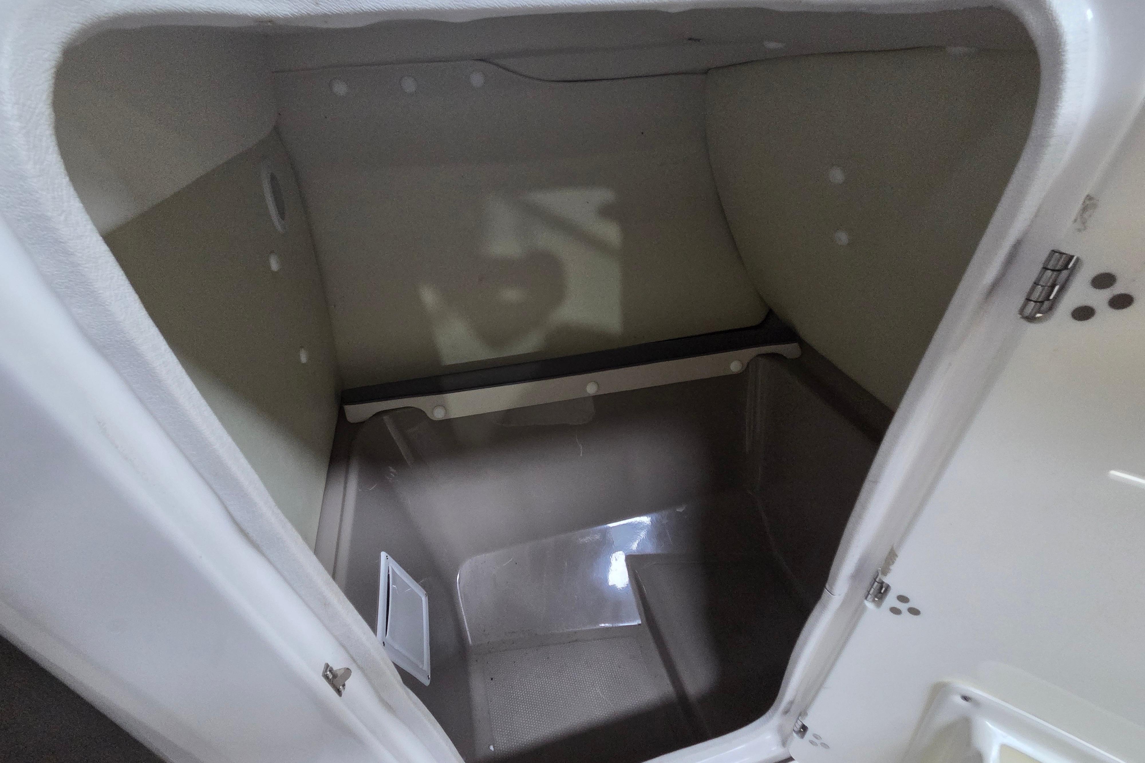 Interior storage compartment of a 2013 Yamaha 242 Limited S boat.