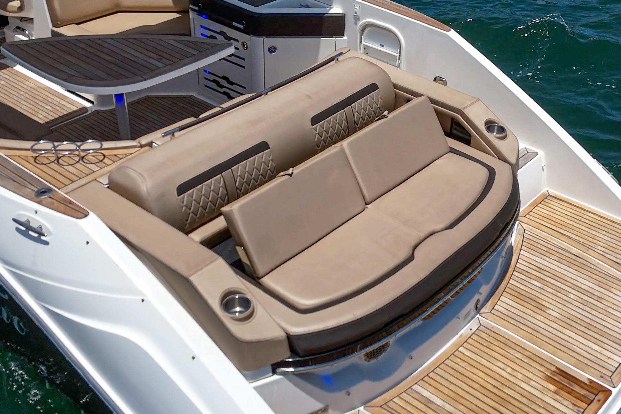 2018 Sea Ray SLX 310 boat interior with luxurious seating and teak flooring.