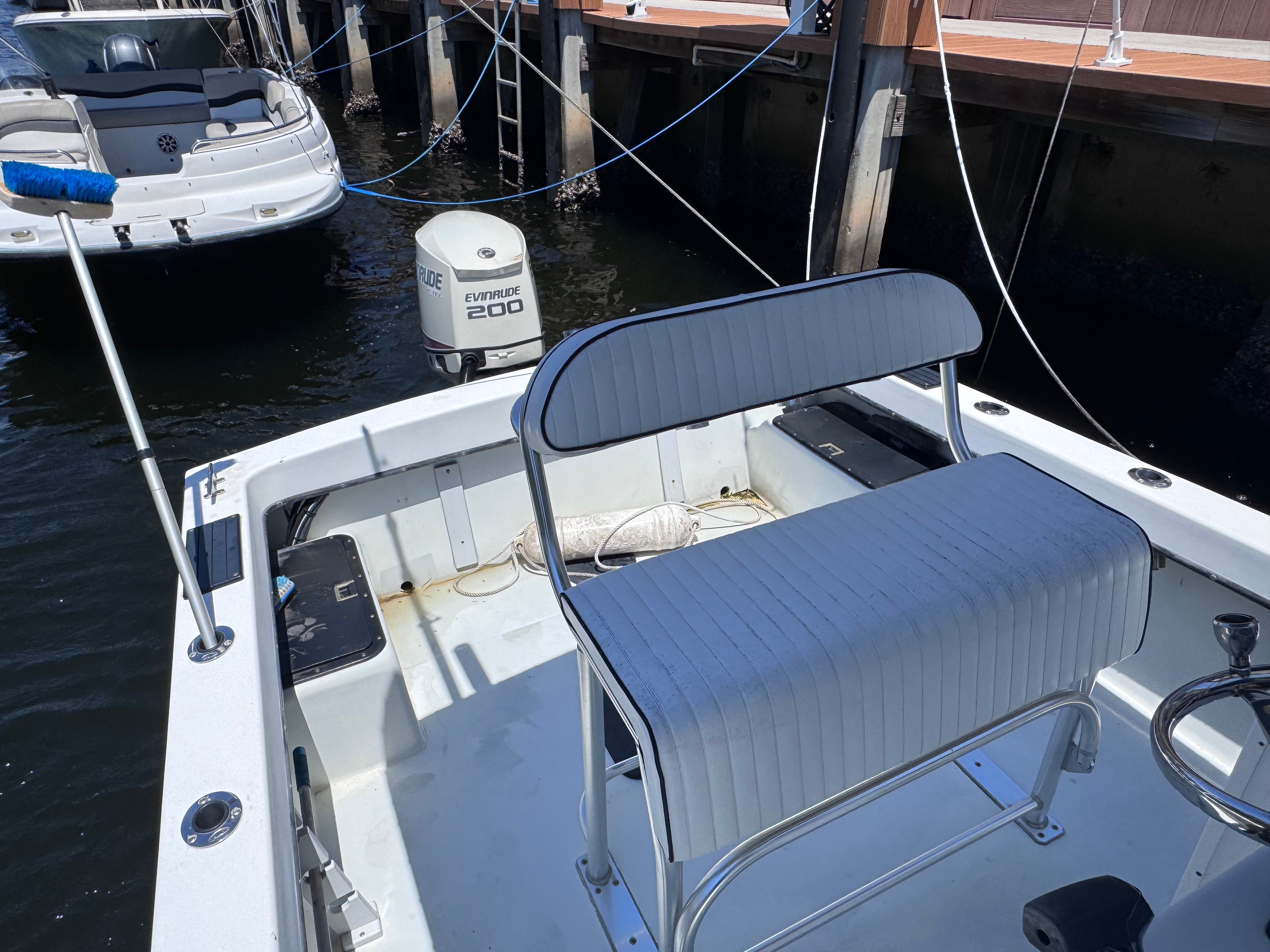 1998 Dusky 20.3 boat with Evinrude 200 motor at dock.