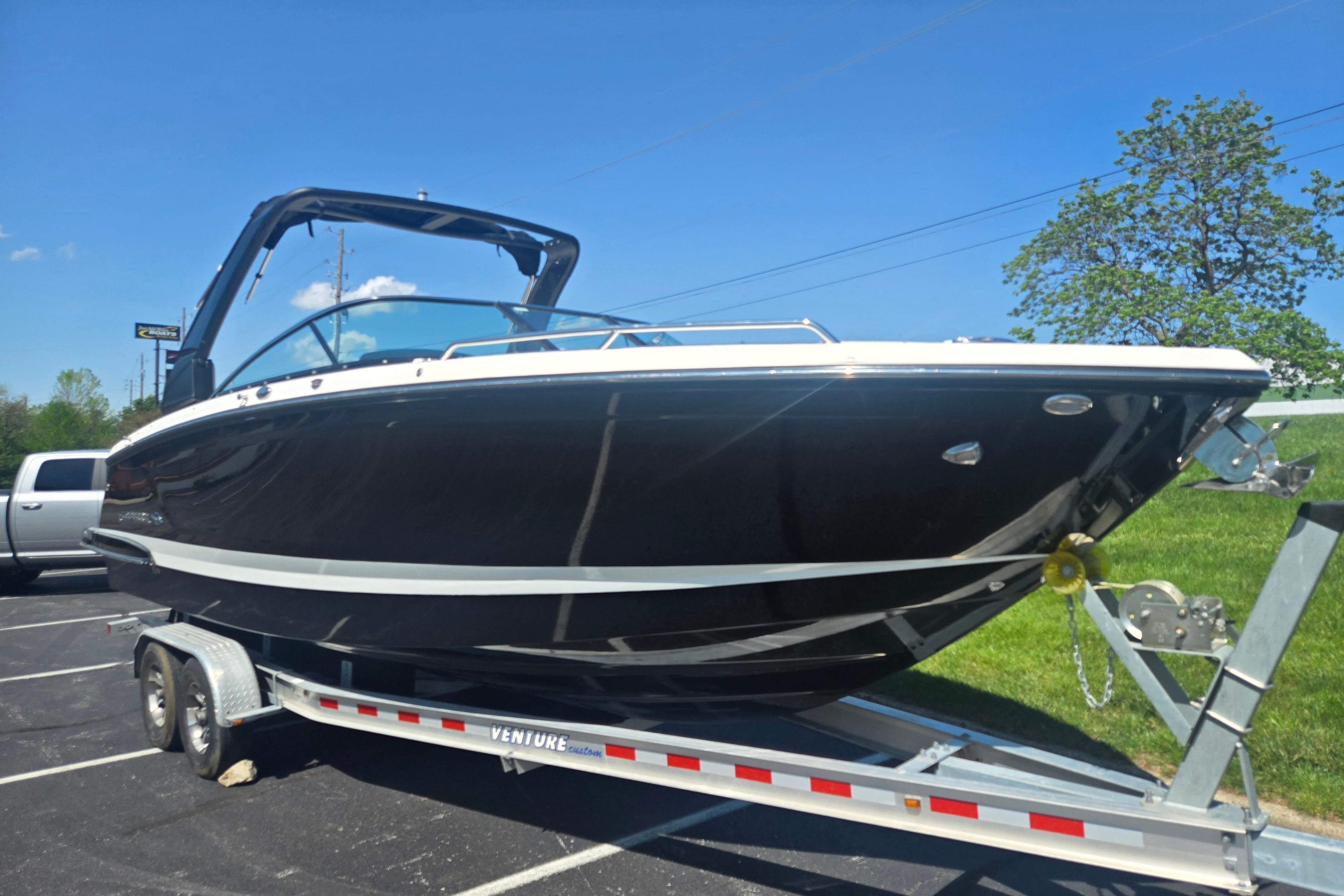 2018 Chaparral 267 SSX boat on trailer under clear blue sky.