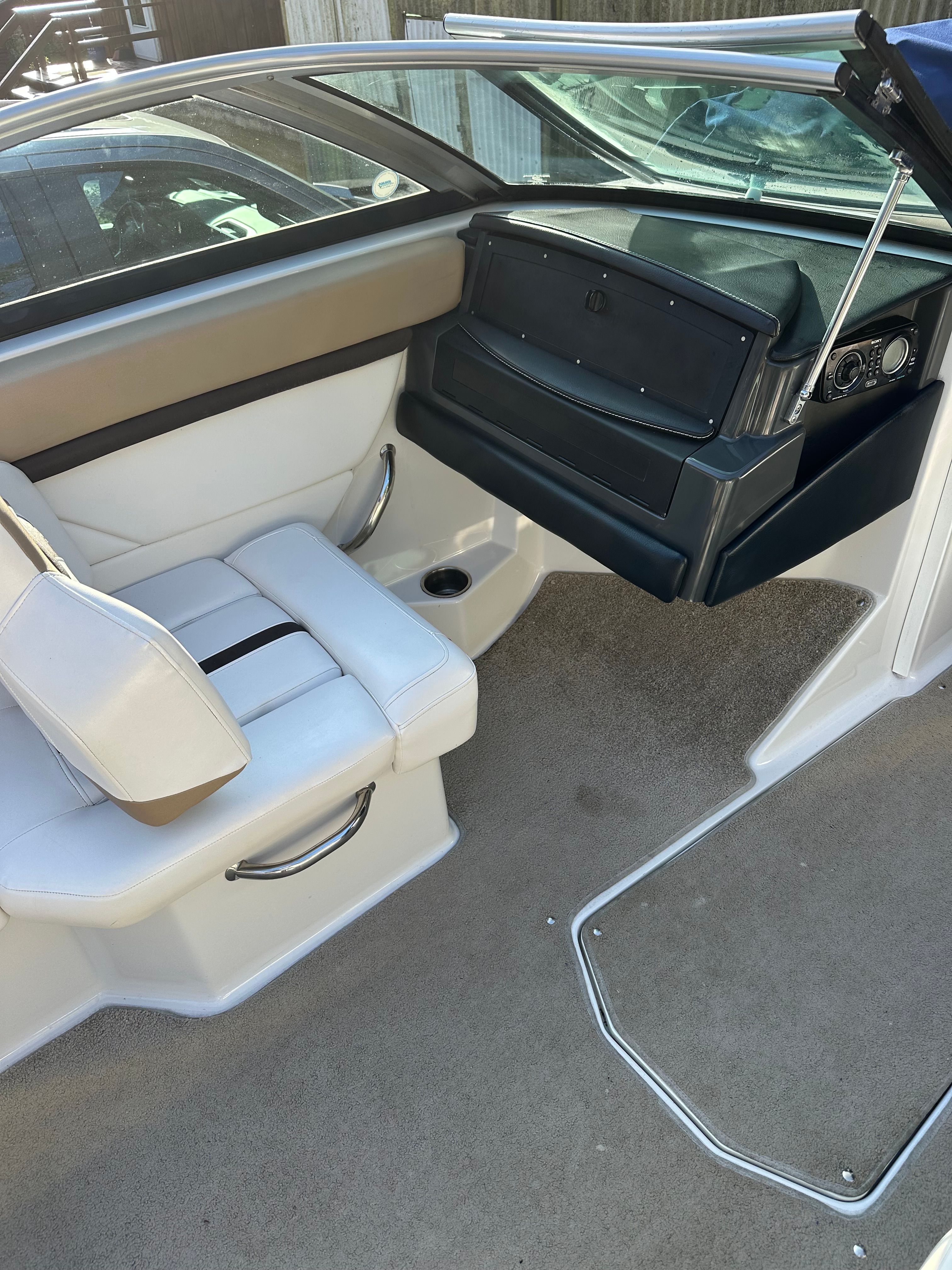 Interior of a 2012 Four Winns H210 boat with white seating.