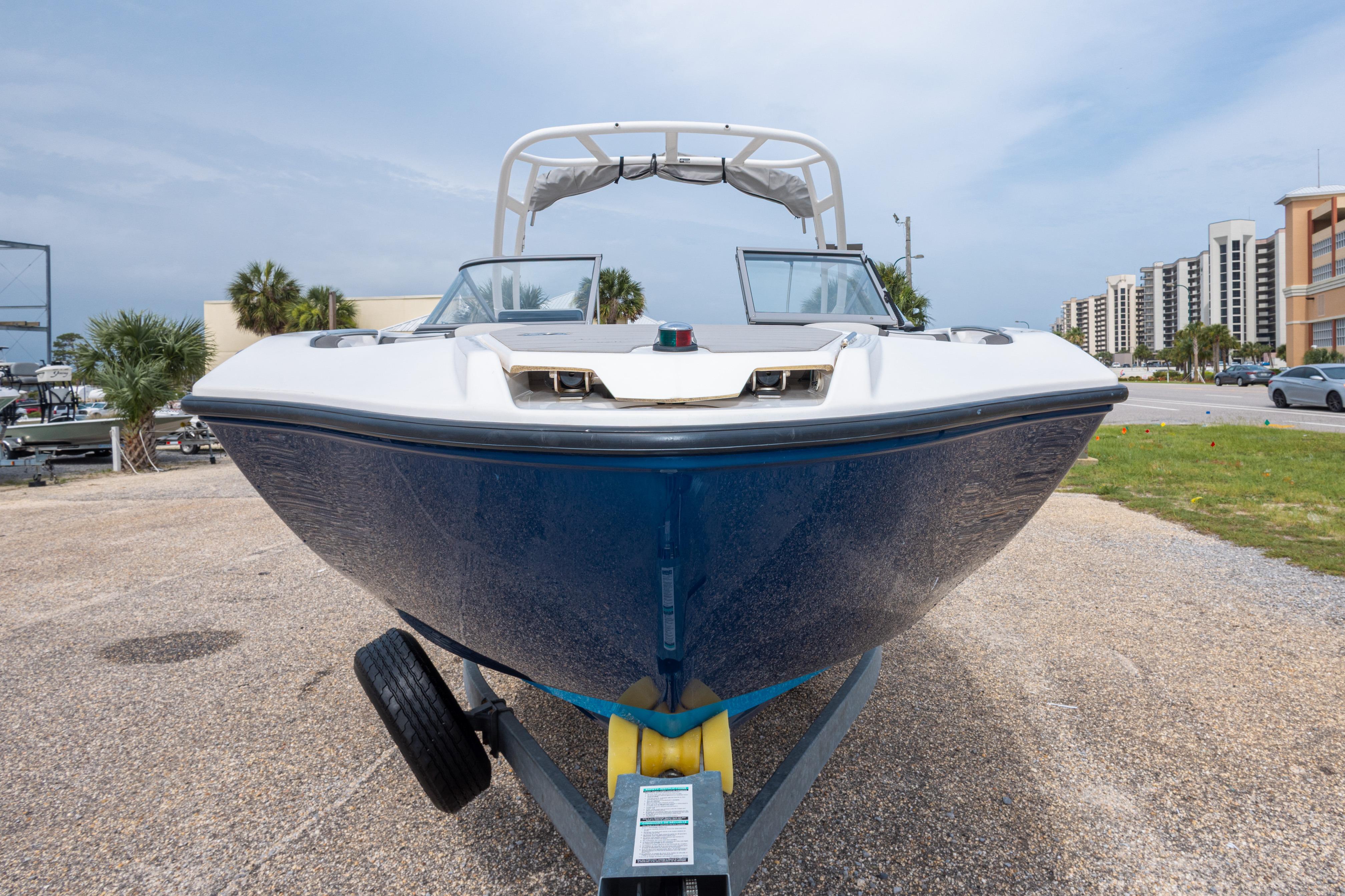 2021 Yamaha Boats AR250 on trailer, front view, parked outdoors near buildings.