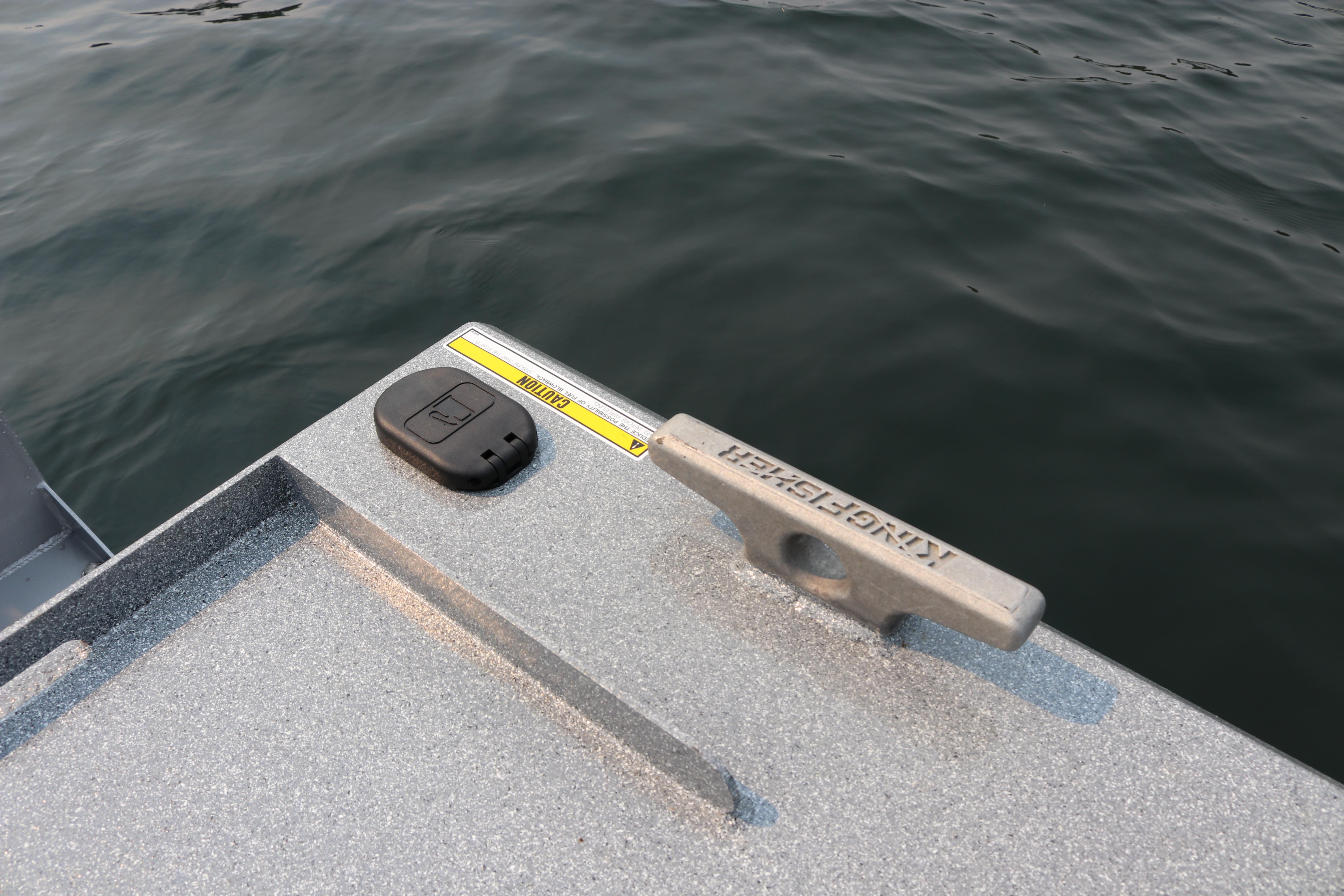 2026 KingFisher 2425 Escape HT boat cleat and control panel by the water.