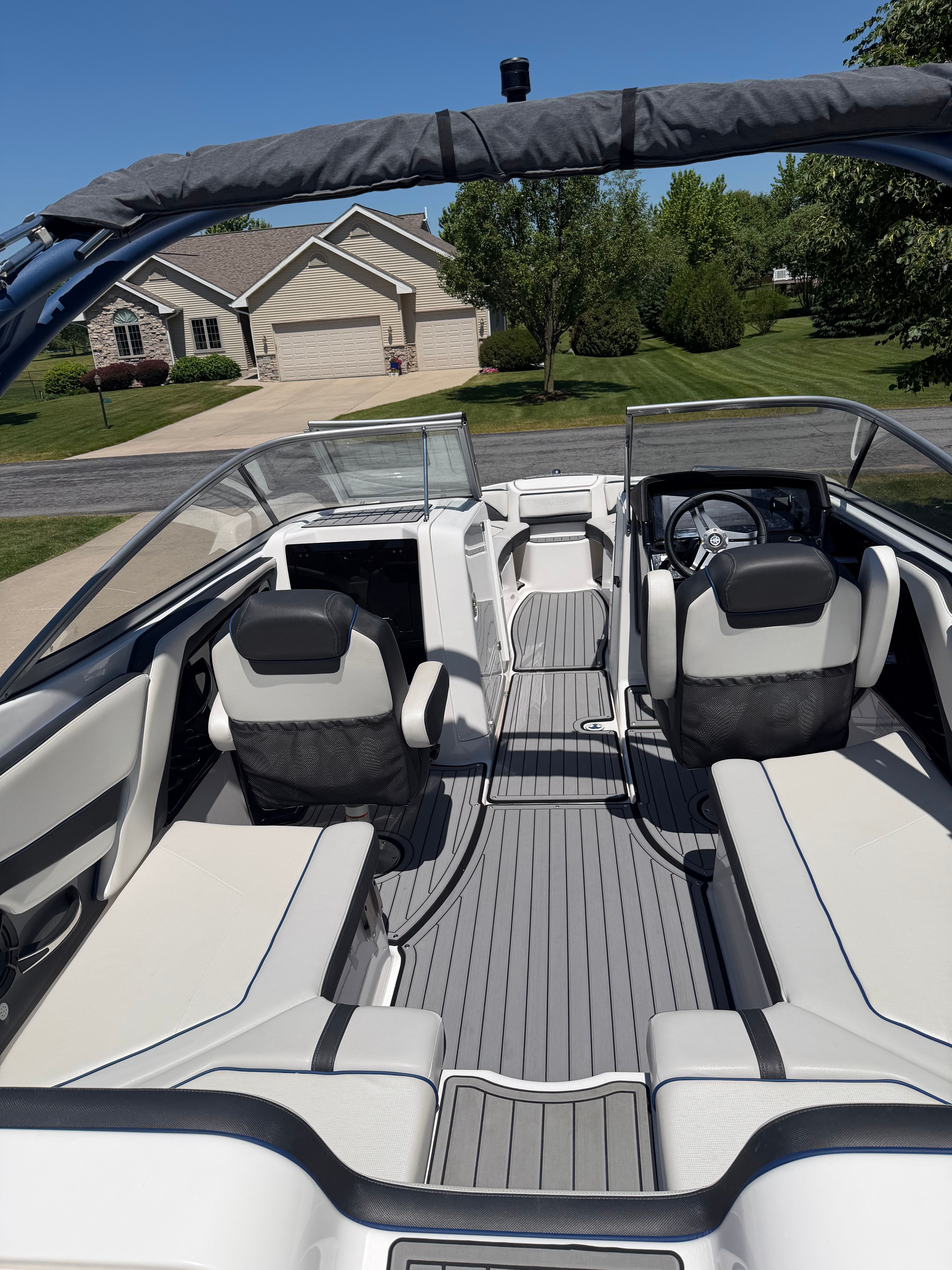 The image shows the cockpit of a 2018 Yamaha 242 Limited S boat with sleek seating.