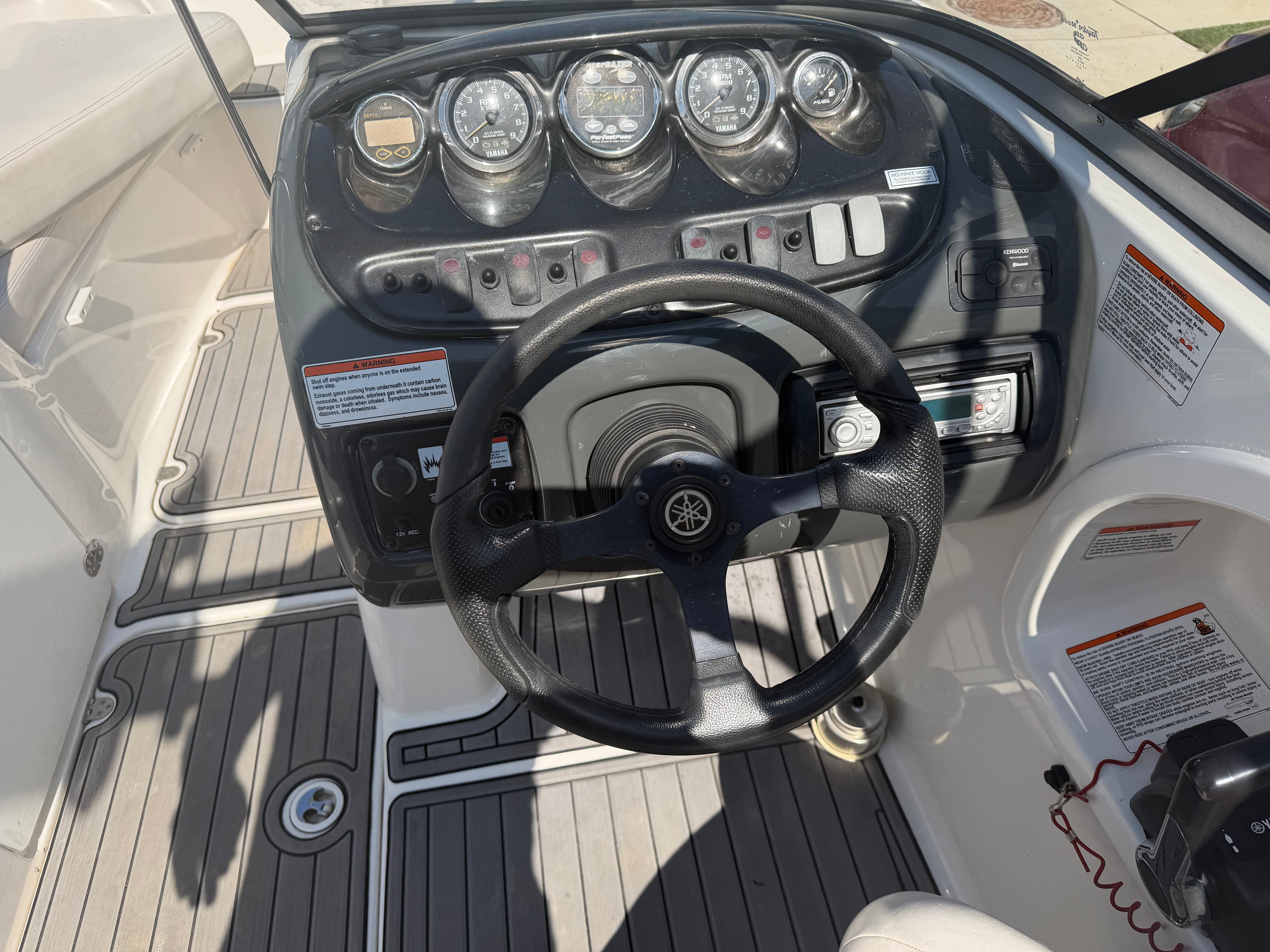 Yamaha AR210 2006 boat dashboard with steering wheel and controls.