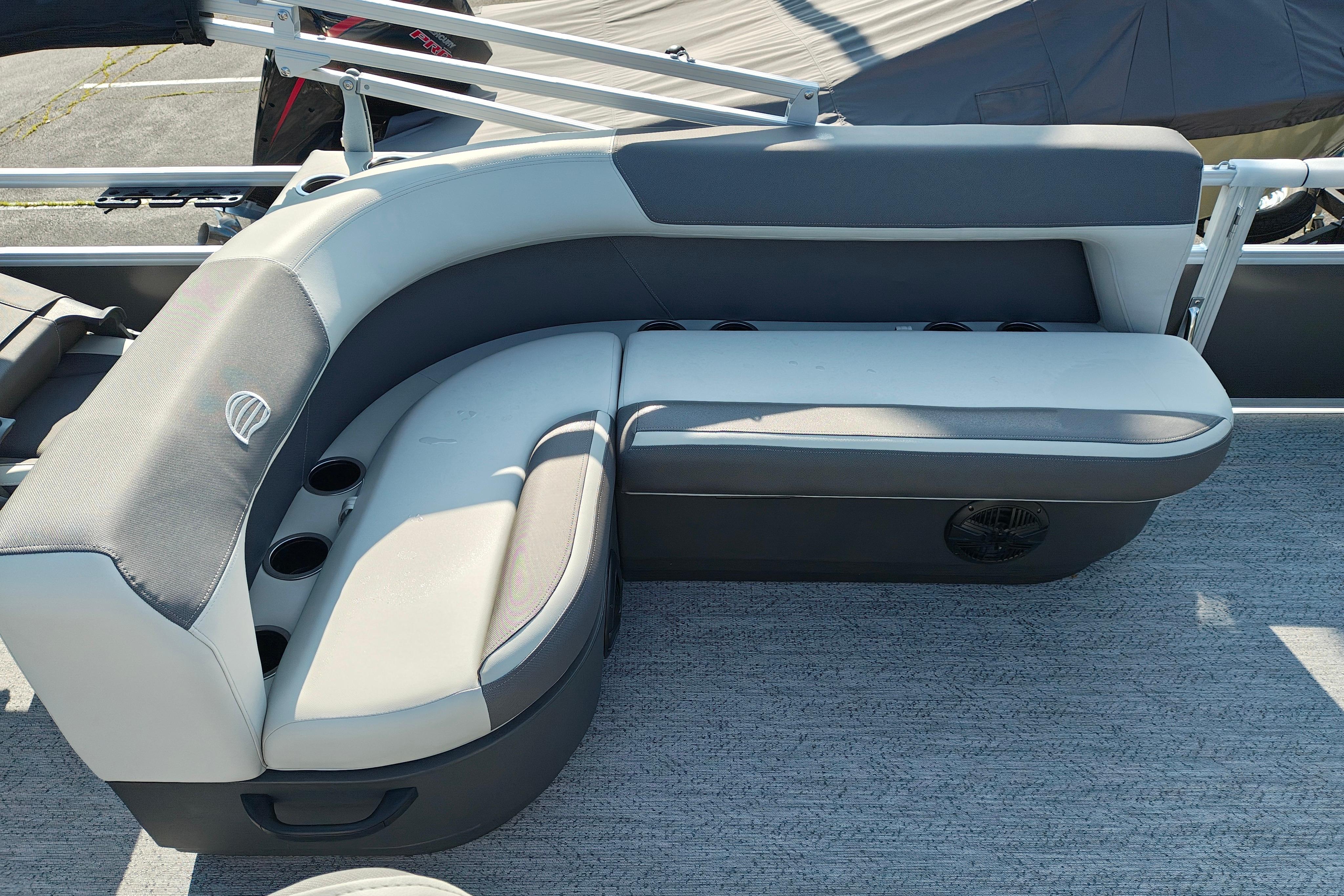 2026 Sun Tracker Bass Buggy 18 DLX pontoon boat seating area with cup holders.